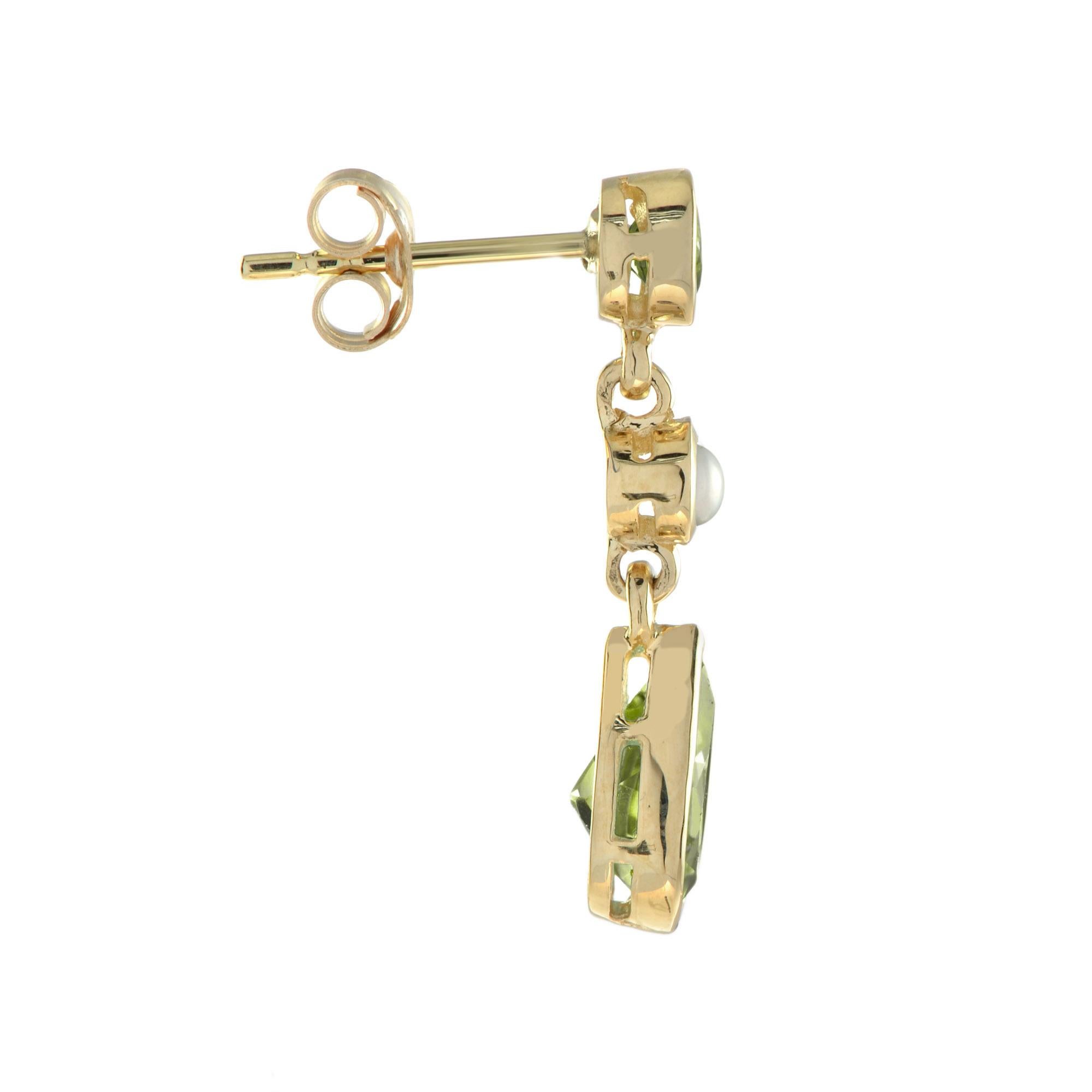 A beautiful pair of 2.30-carat peridot drop shapes suspended from two pearls and round peridot. 14K Yellow Gold. 
Width: 7 mm.
Length: 24 mm.
Weight: 3.50 g. (approx. total weight)
Backing: Push Back
Center Gemstones
Type: Peridot
Shape: Tear Drop &