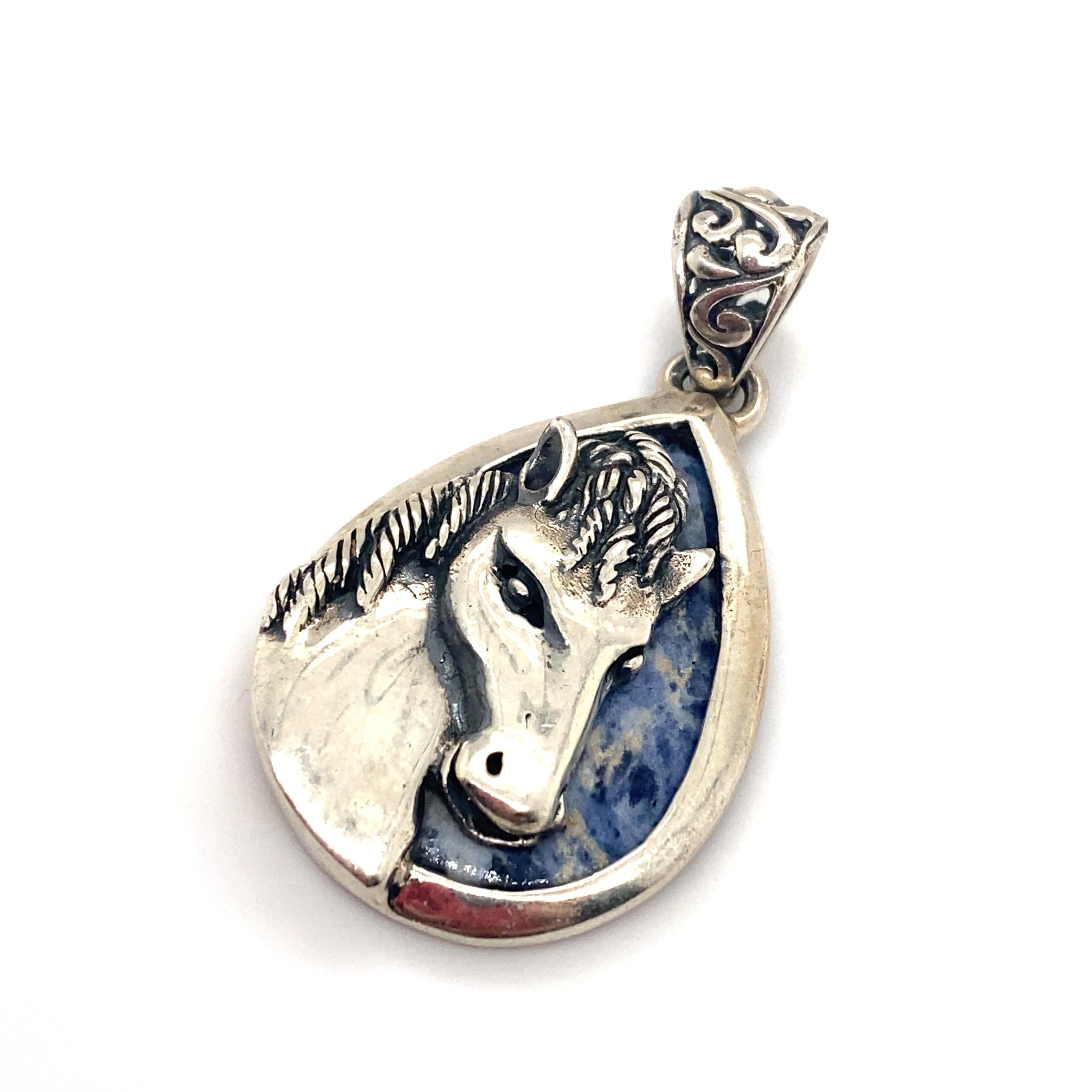 Item Details: This equestrian charm has a backing of a pear shaped labradorite and filigree detailing.

Circa: 21st Century
Metal Type: Sterling silver
Weight: 6.4g
Size: 1.5