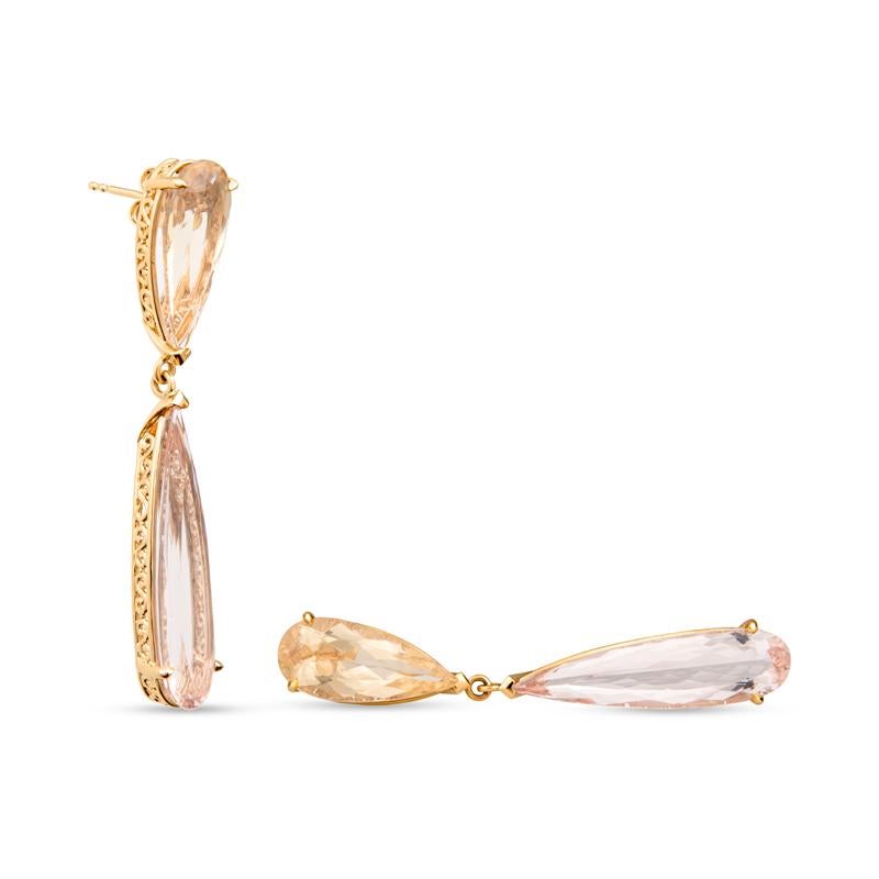 Opposites attract with these unique earrings. They feature 28.10 carat total weight in pear shaped yellow beryl and morganite and are set in 18 karat yellow gold with unique handmade filigree detailing that dangle from one's ear. Friction post and