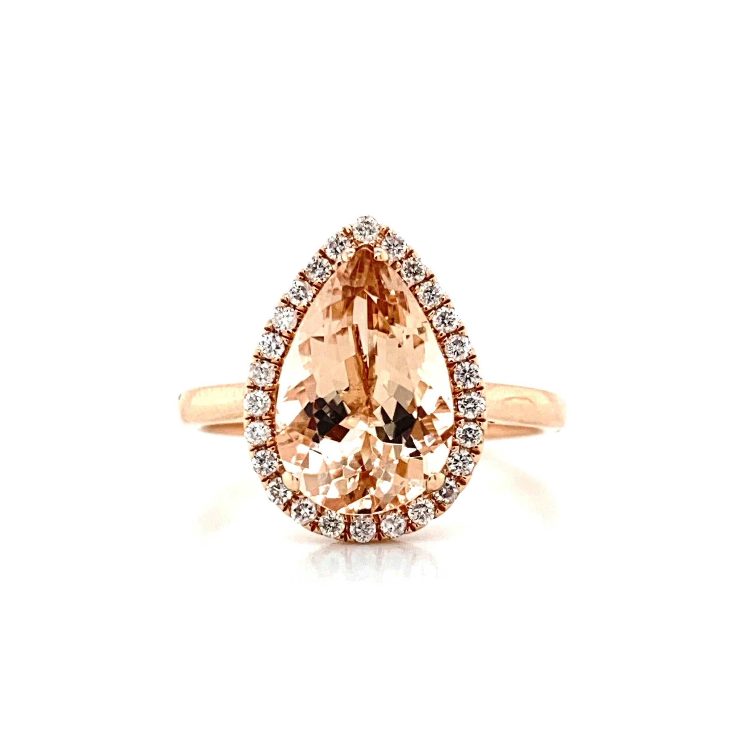 This flawless natural 2.79 carat morganite and diamond ring is set in solid 14K rose gold is a true showstopper. This ring has a natural 12x8MM pear cut morganite stone with excellent peachy pink color (AAA quality gem) and is surrounded by a dainty