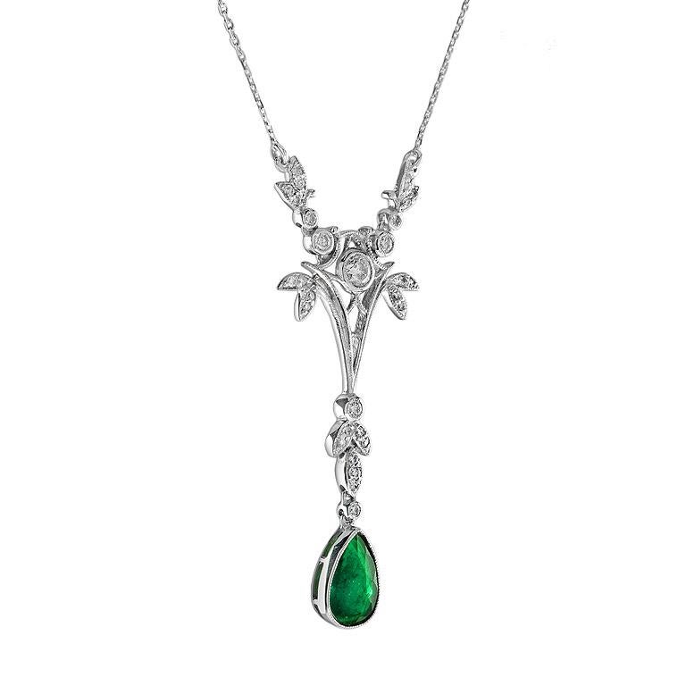 This floral-designed necklace spectacularly displays a fine pear-shaped natural Emerald studded excellently in a classic 18K white gold setting on the charismatic floral pattern with tiny glistening round brilliant cut diamond held elegantly on a