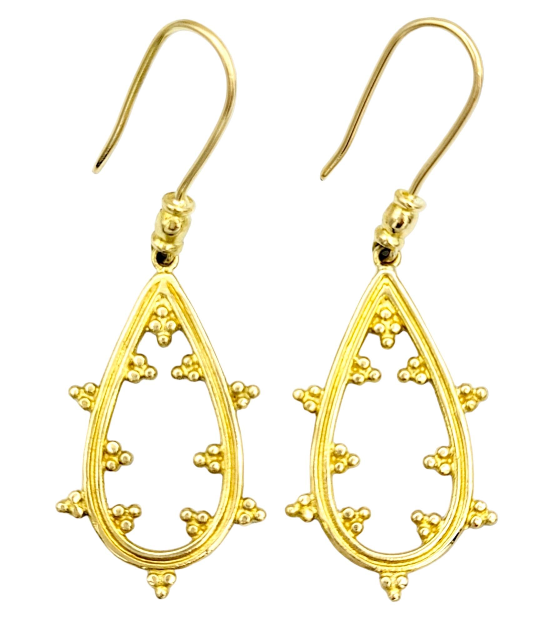These pear-shaped dangle earrings, crafted in beautiful 18 karat yellow gold, exude a timeless elegance that will elevate your jewelry collection. 

These earrings are made up of entirely yellow gold, molded into a beautiful open pear shape that