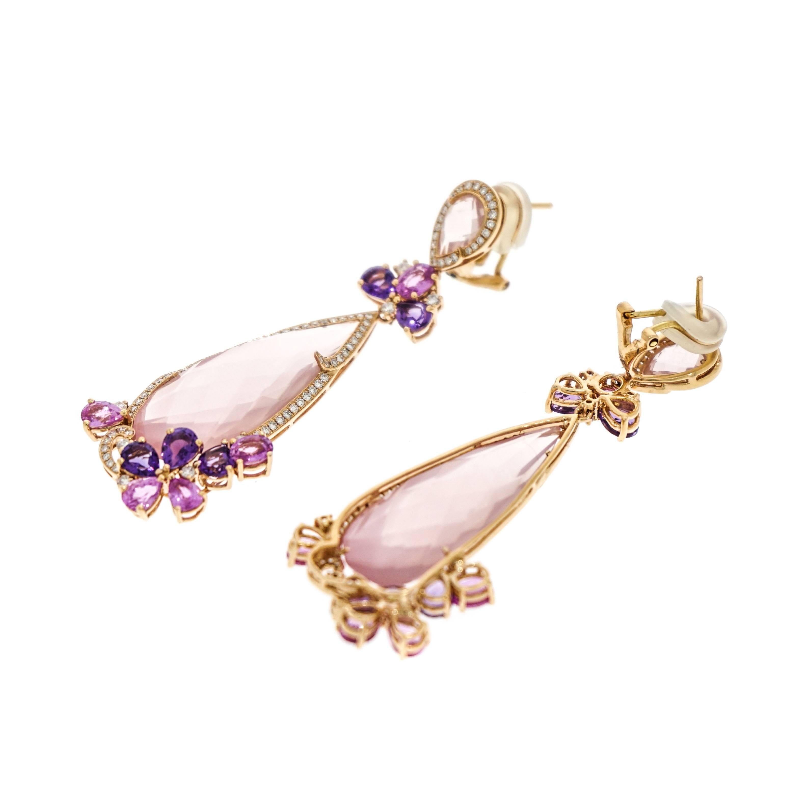 We embrace colors and we mixed them playfully to create this pair of earrings. Impactful is the word that comes to mind describing this gorgeous earrings, designed with a pear shaped Pink Quartz, Pink Sapphires and deep purple Amethyst, surrounded