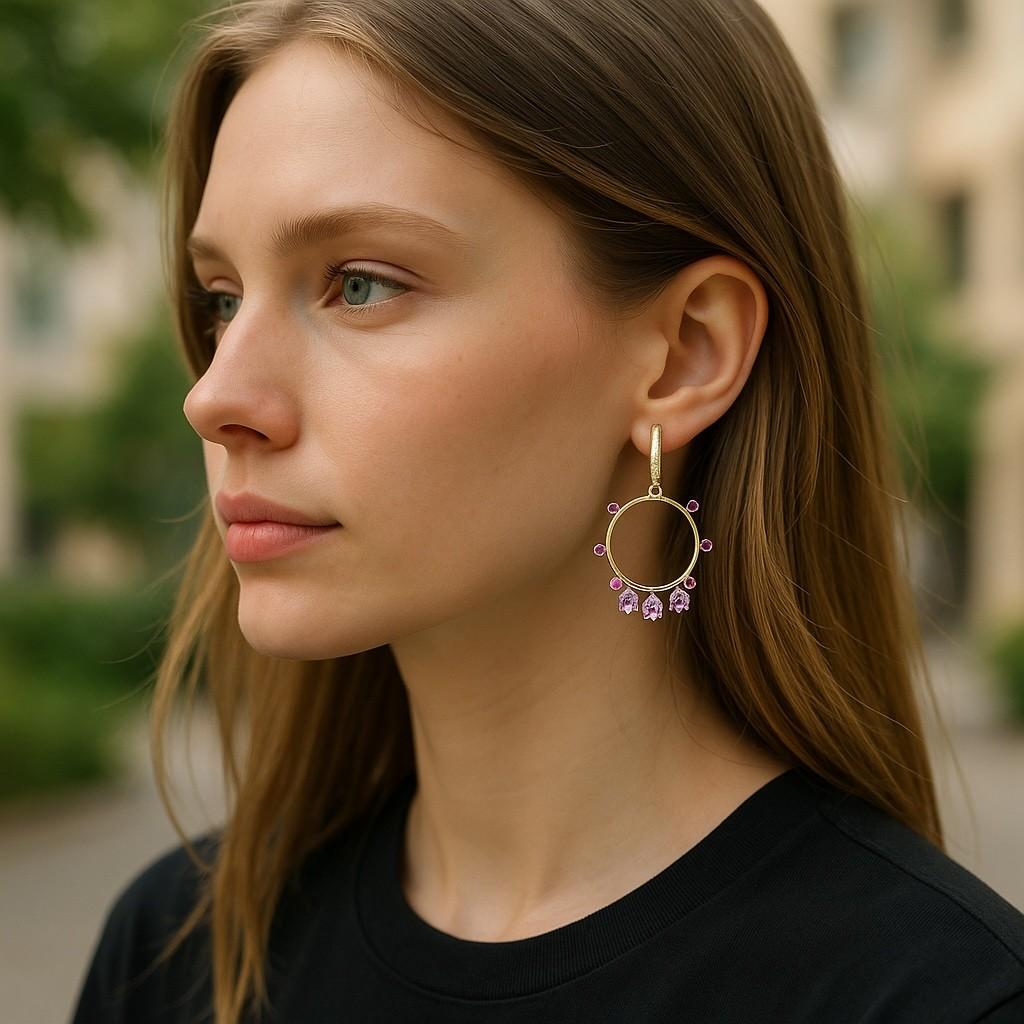 This exquisite pair of earrings is crafted in 14-karat yellow gold, designed to add a touch of luxury to any ensemble. Each earring features a meticulously arranged cluster of six pear-shaped Ceylon pink sapphires, collectively weighing 1.68 carats,