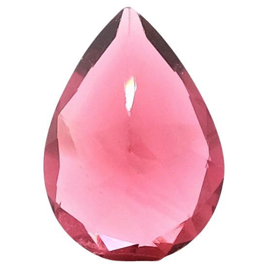 This 1.81-carat pear-shaped red tourmaline, sourced from Mozambique, glows with a deep, fiery red hue that symbolizes passion, strength, and vitality. 

Known as the “Stone of the Heart,” red tourmaline is believed to inspire love, confidence, and