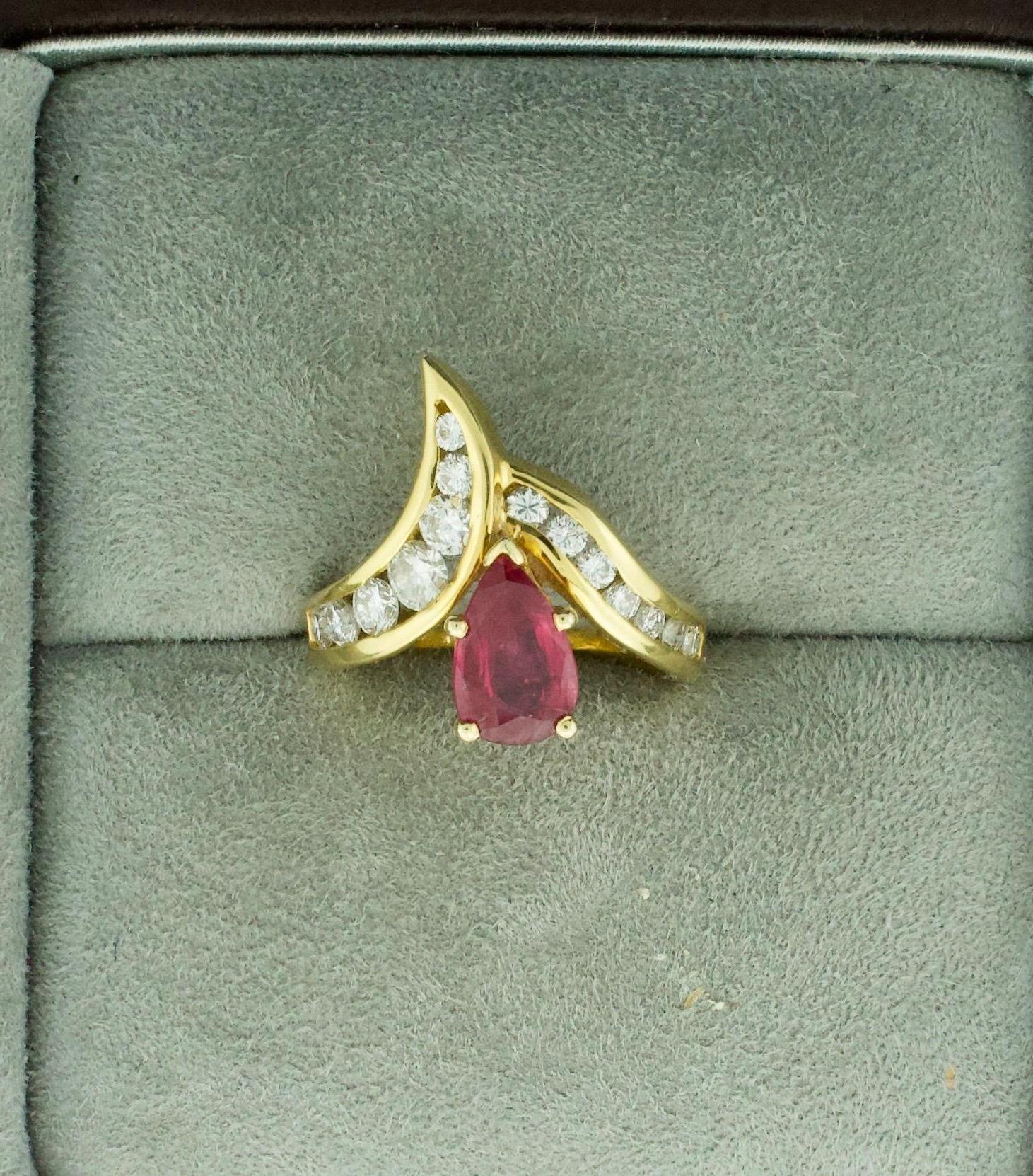 Pear Shaped Ruby and Diamond Ring in 18k
One Pear Shape Ruby weighing 1.28 carats  [beautiful color and clarity] 
Fourteen Round Brilliant Cut Diamonds weighing .80 carats approximately [GH VVSi - VS1]
Currently Size 5.5 Can Be Sized By Us Or Your