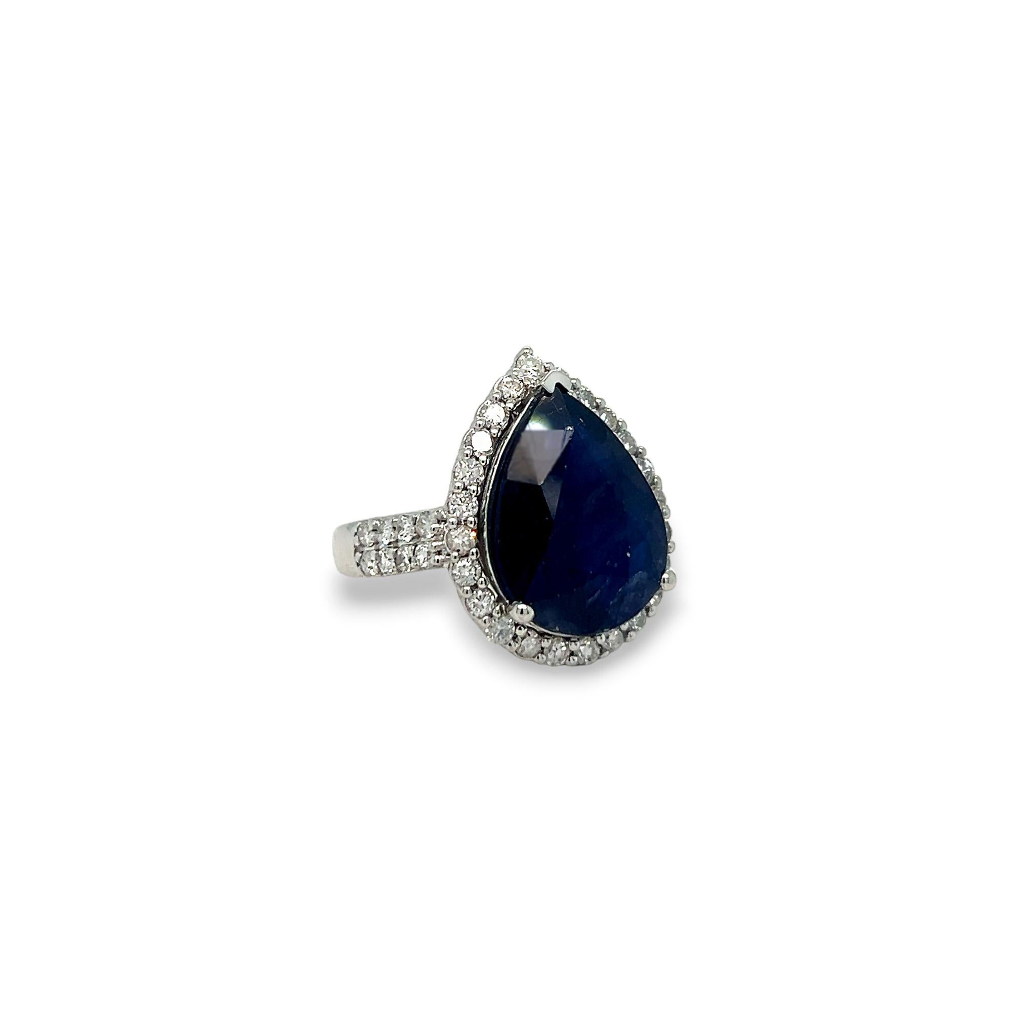 This gorgeous statement ring features a beautiful 11.23 carat pear shaped sapphire center stone and a halo of round diamonds. The side diamonds on the band as well as those that comprise the halo are 1.18 carats total weight, H/I color, and SI