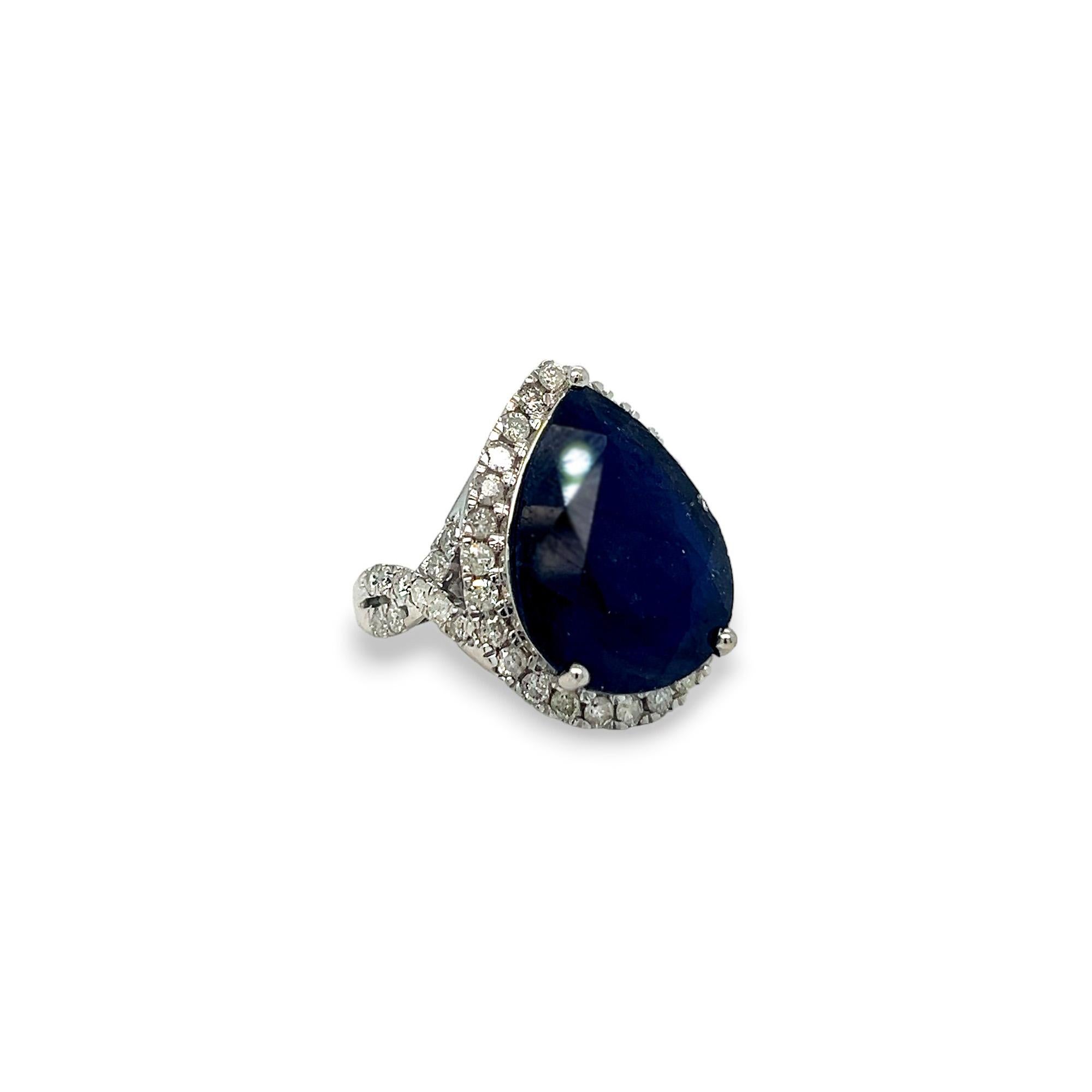This gorgeous statement ring features a beautiful 17.01 carat pear shaped sapphire center stone and a halo of round diamonds. The side diamonds on the crisscross band as well as those that comprise the halo are 1.44 carats total weight, H/I color,
