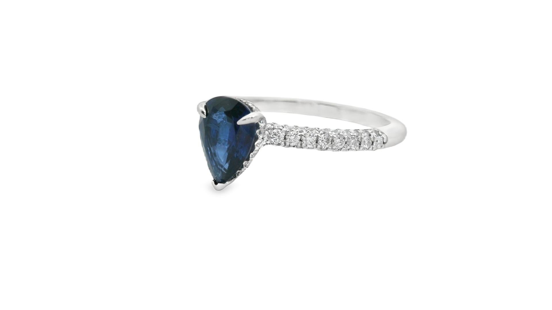 Refined and contemporary, this 14K white gold ring features a striking 1.00-carat pear-shaped sapphire accented with 85 round diamonds totaling 0.41 carats. The rich blue center stone commands attention with its elongated teardrop shape, securely
