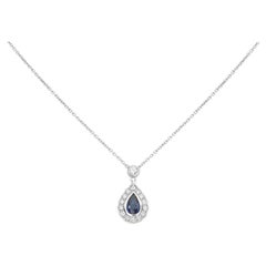 Pear-Shaped Sapphire, White Diamond, and 18 Karat White Gold Halo Necklace