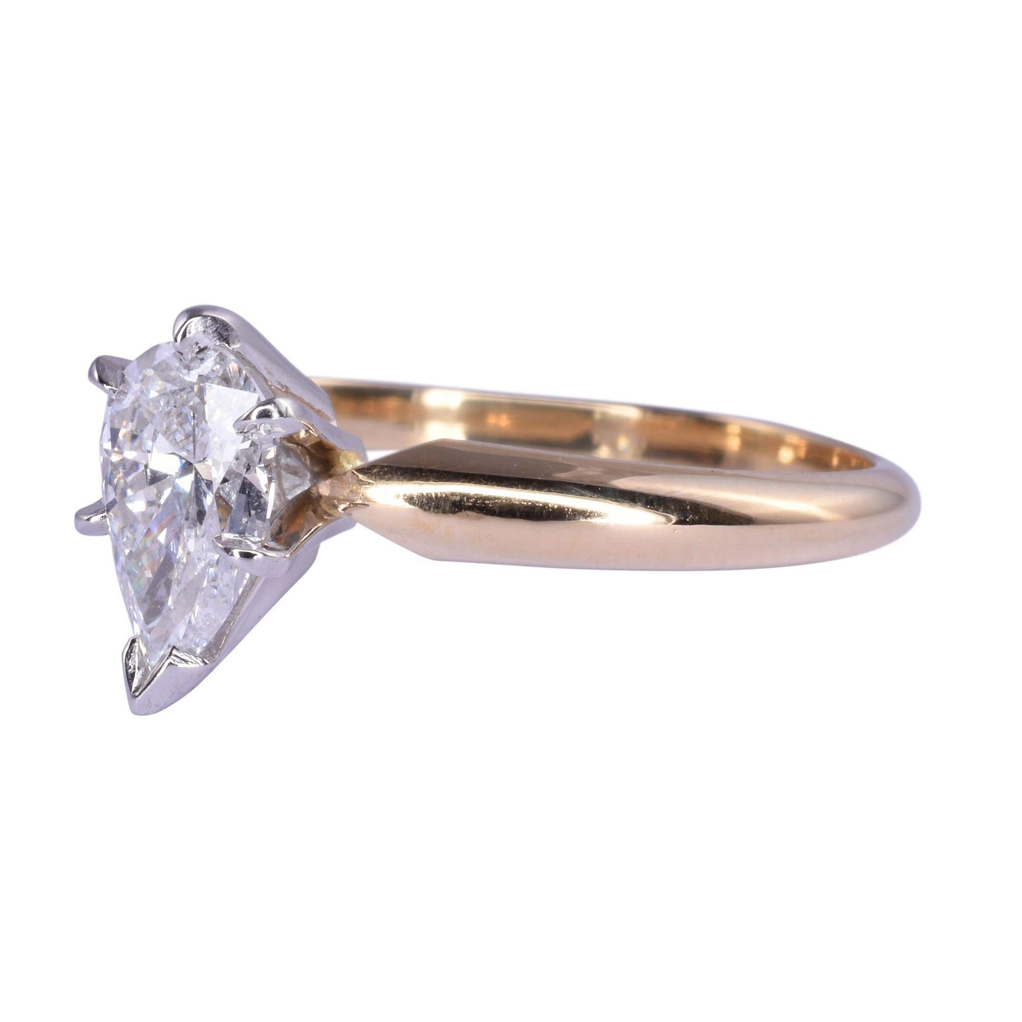 Estate pear solitaire diamond engagement ring. This ring has an 18 karat yellow gold shank with a platinum head. The .82 carat pear diamond has I1 clarity and F color. This diamond ring weighs 2.73 grams, is appraised at $3,900, and is a size 6.5.