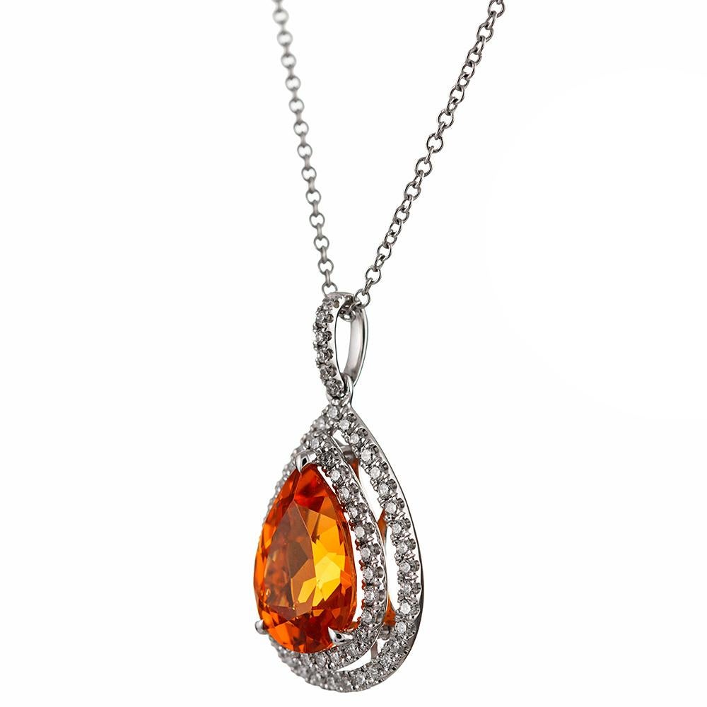 A clean and classically-styled pendant with a pear spessartite garnet center stone bordered with a double row of brilliant white diamonds. The major stone weighs 3.36 carats and exhibits a rich and intense tone that is neutral and complimentary to