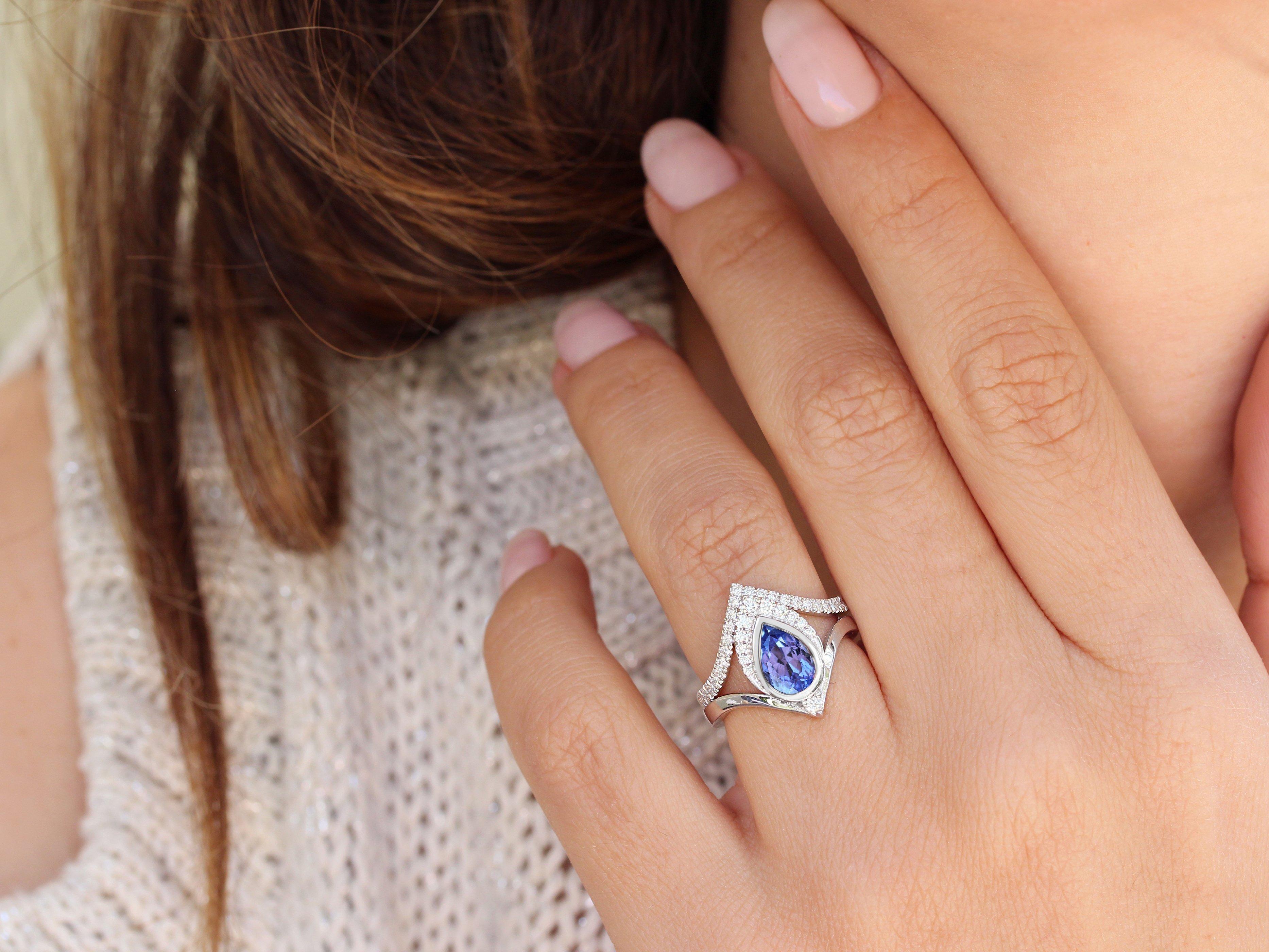 Beautiful pear-shaped Tanzanite engagement rings set with diamonds. 
The list is for two ring set. 
Beautiful and outstanding design, royal look.
Hand made with care. 
An original design by Silly Shiny Diamonds. 

Details: 
* Center Stone Shape: