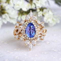 Pear tanzanite with halo twist infinity shank wedding ring set, Iceland