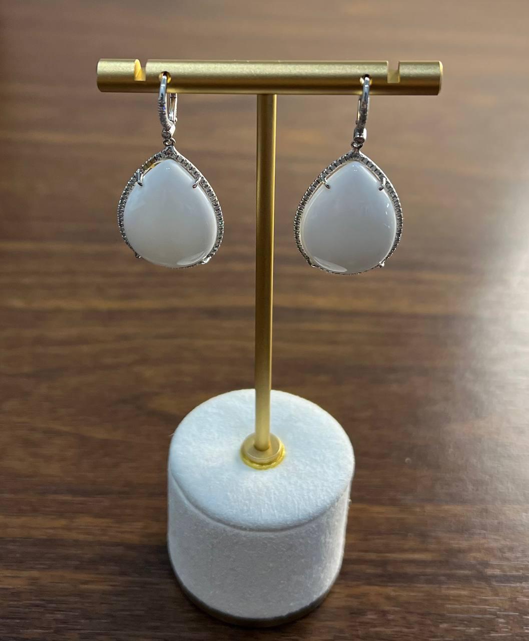 Elegant drop earrings featuring pear-cut white agate stones, framed by a delicate halo of white diamonds. Crafted in 14k gold, these unbranded jewels exude a refined charm.