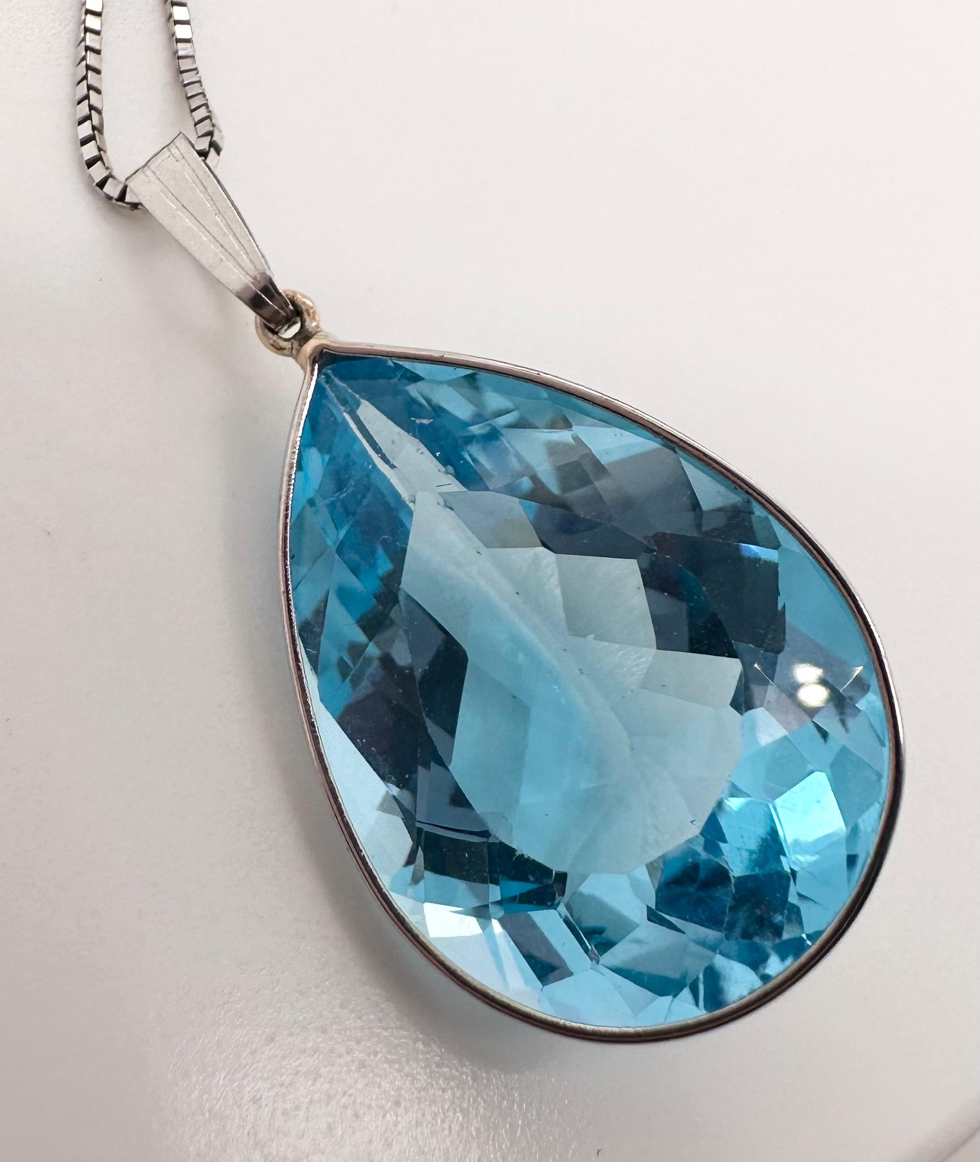 Modern and simple blue topaz pear shape pendant necklace, the pear topaz is large at 25 carats and 12x10mm size.
Item will come with a box, certificate of authenticity.

Metal: 14KT white gold
Carat: 25ct total
Center Stone: Certified Topaz
Color: