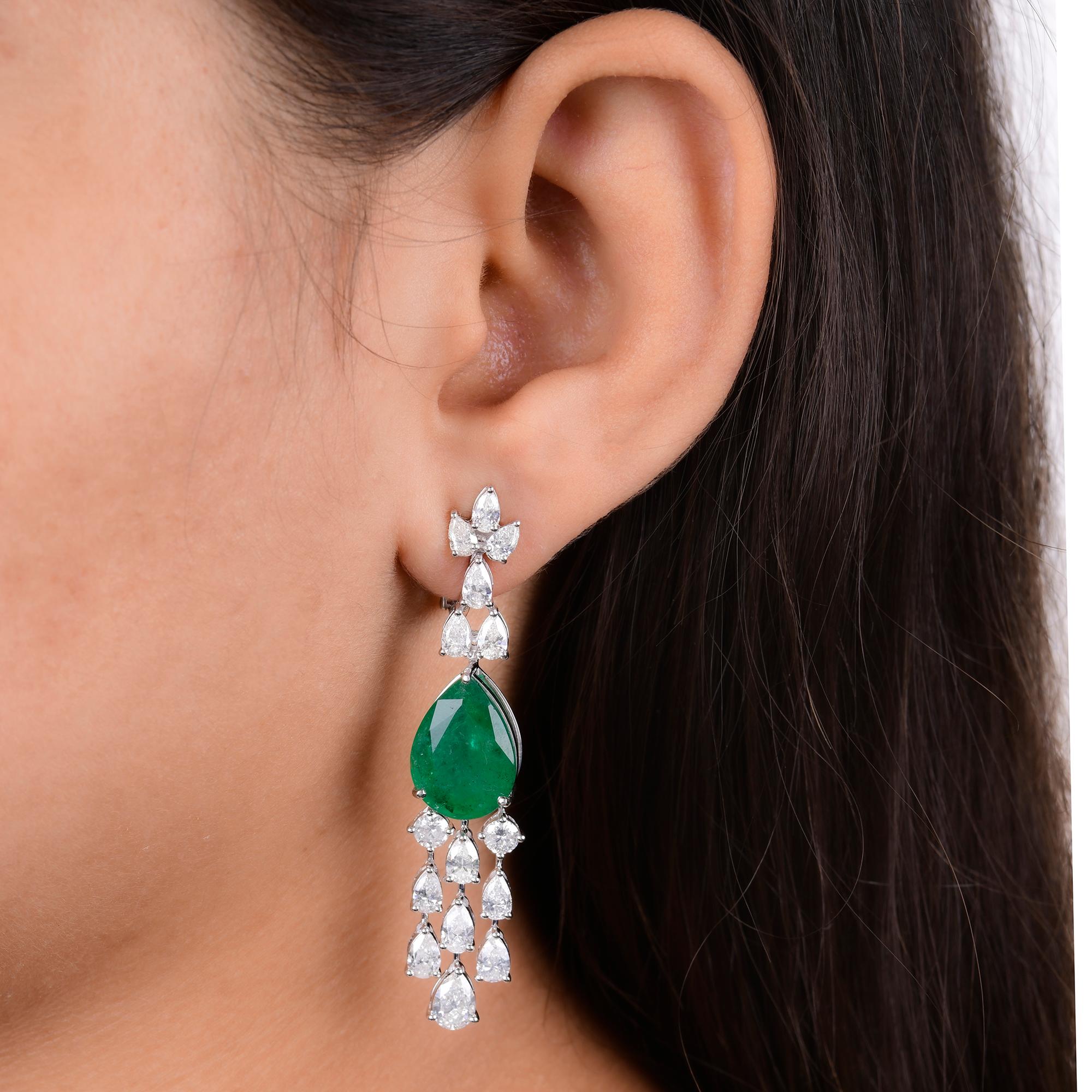 Elevate your elegance with the enchanting beauty of these Pear Zambian Emerald Gemstone Chandelier Earrings, embellished with sparkling Diamonds and meticulously crafted in luxurious 14 Karat White Gold. These exquisite earrings are a celebration of