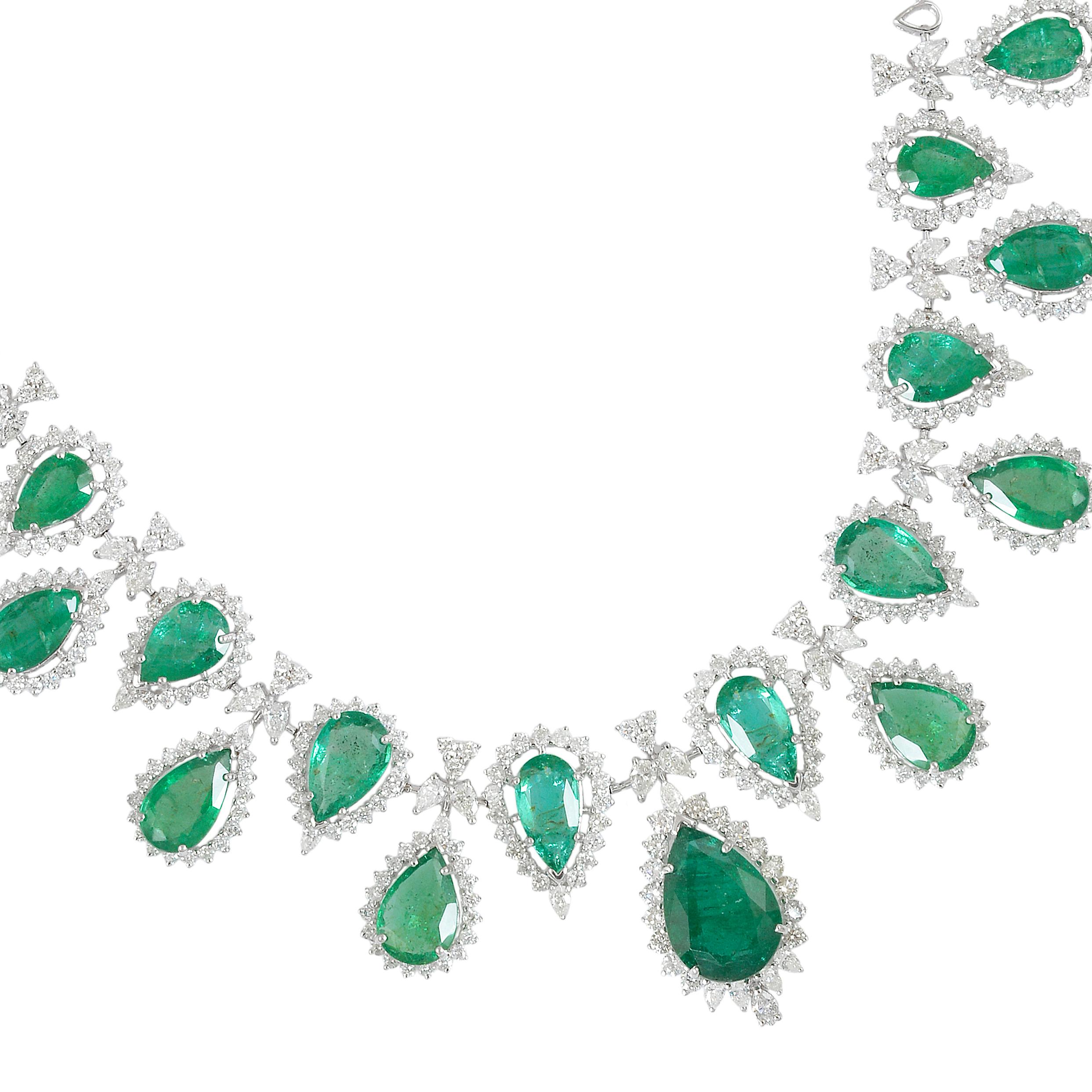 This exquisite necklace features a pear-shaped emerald gemstone accentuated with diamonds, all set in 18 karat white gold. Meticulously handcrafted with exceptional attention to detail, this piece of fine jewelry radiates elegance, sophistication,