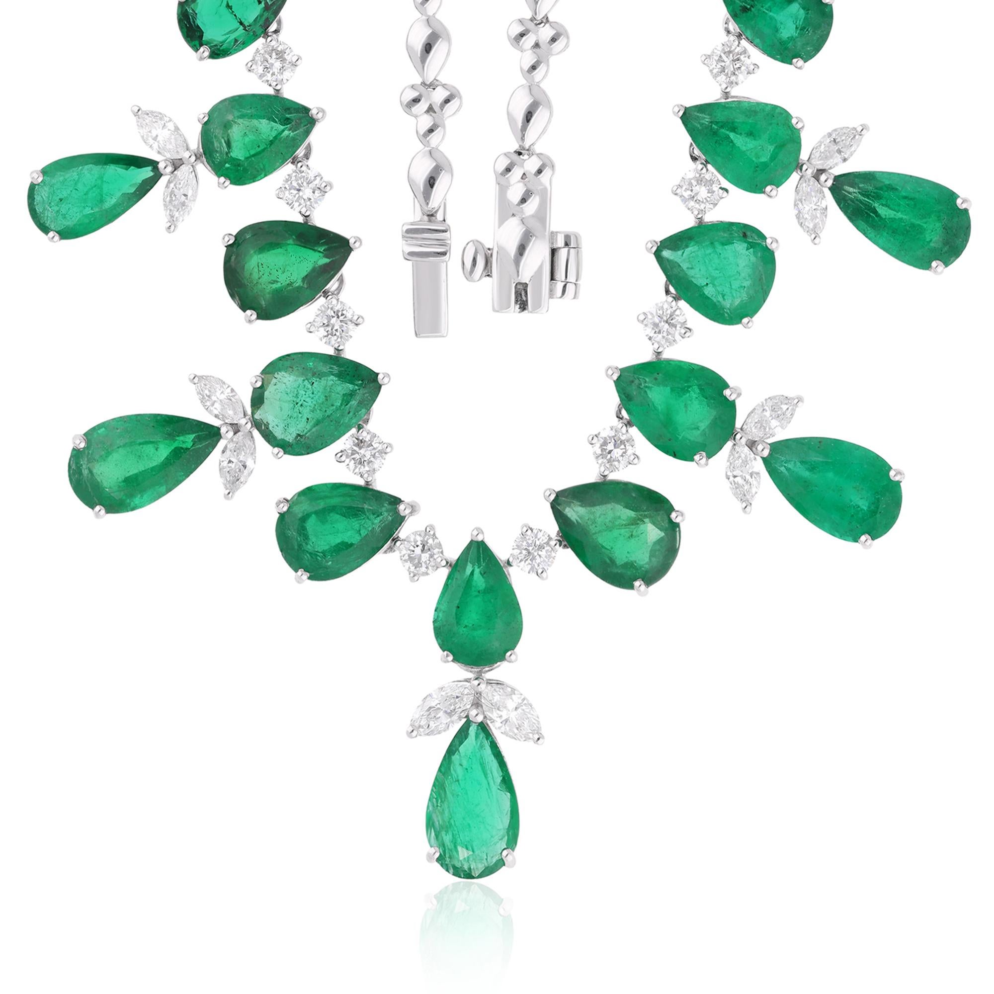 Embrace the enchanting allure of nature's finest with this exquisite necklace featuring a captivating pear-shaped Zambian emerald gemstone accented by round and pear-shaped diamonds, all set in luxurious 14 karat white gold. Designed to evoke a
