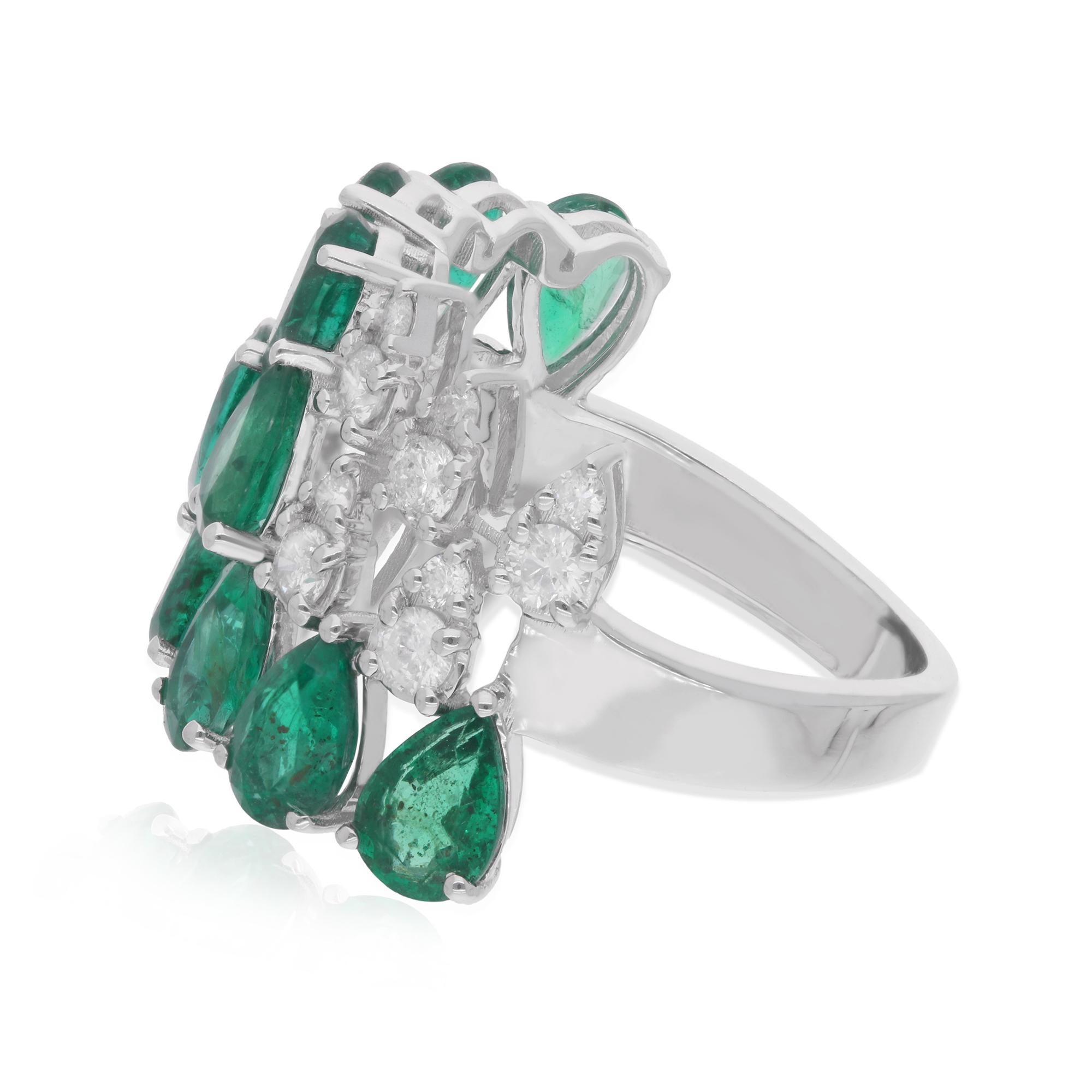 Step into a world of enchantment with this mesmerizing handmade jewelry masterpiece – a pear-shaped Zambian emerald gemstone ring accented with diamonds, set in 14 karat white gold. Imbued with the essence of luxury and sophistication, this
