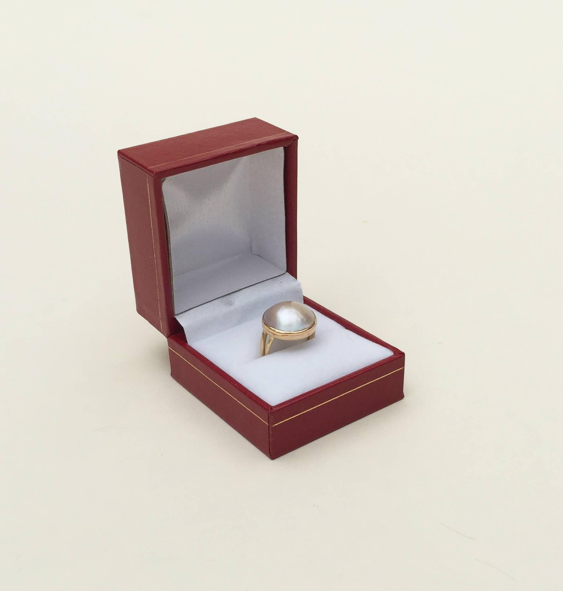 This delicate pearl and 14k yellow gold ring (size 4) has an iridescent glow. The blue gray pearl is elegant, beautiful and has no blemishes. This ring is classic in design, fitting well with any outfit as the perfect final touch for the modern