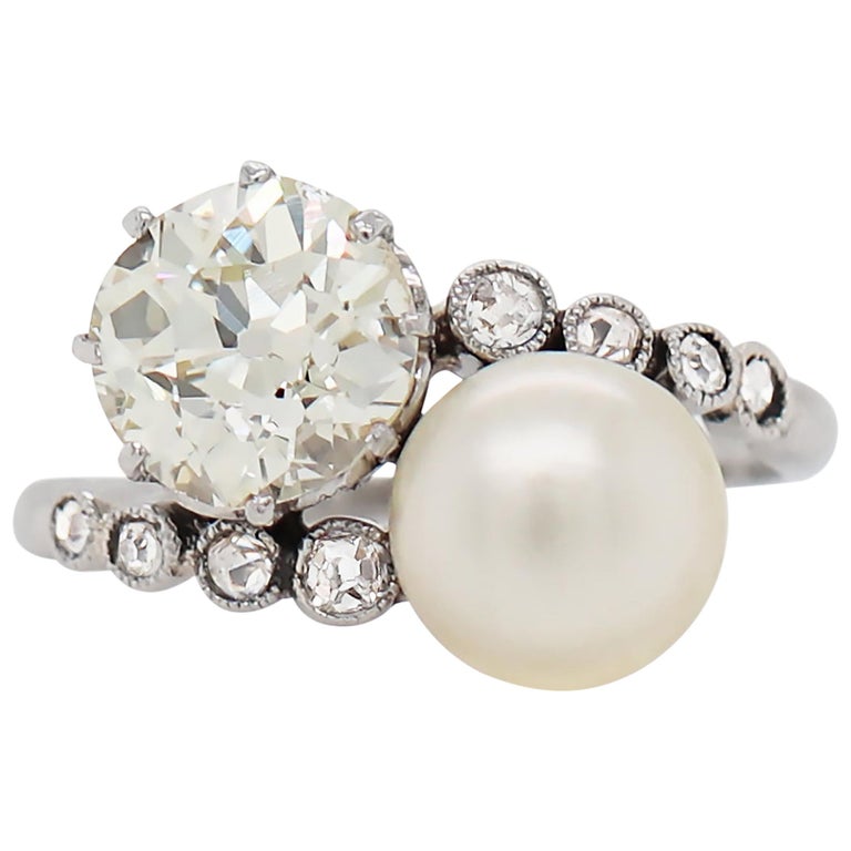 Pearl and 1.69ct Old Cut Diamond Two Stone Crossover Platinum Ring, circa 1920s For Sale