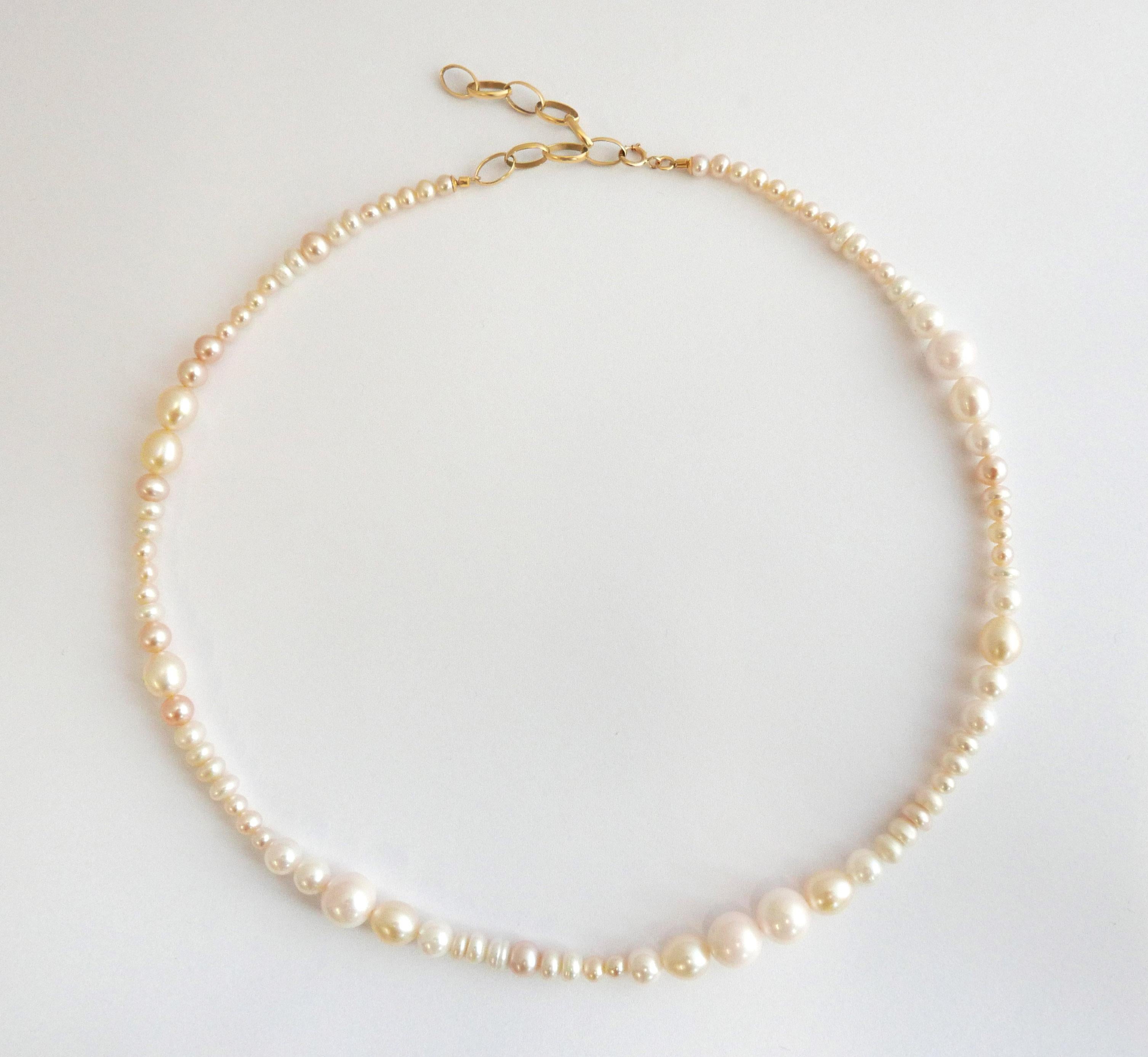 This freshwater pearl necklace features an arrangement of mixed sizes, shapes and subtly varying tones of freshwater pearls for a fresh and modern effect.  The pearls range in tone from pale blush to cream and in size from 4mm to 8mm in diameter.