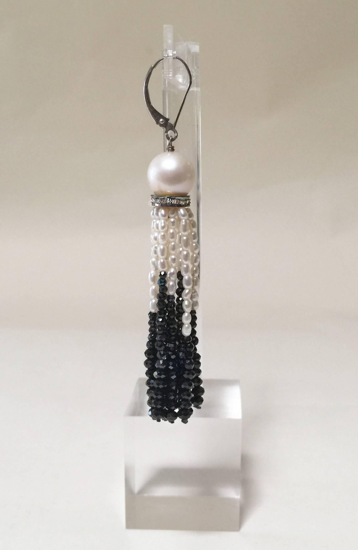 These elegant earrings start with a large 9 mm pearl, followed by a diamond encrusted silver roundel. The tassel is composed with luminous 