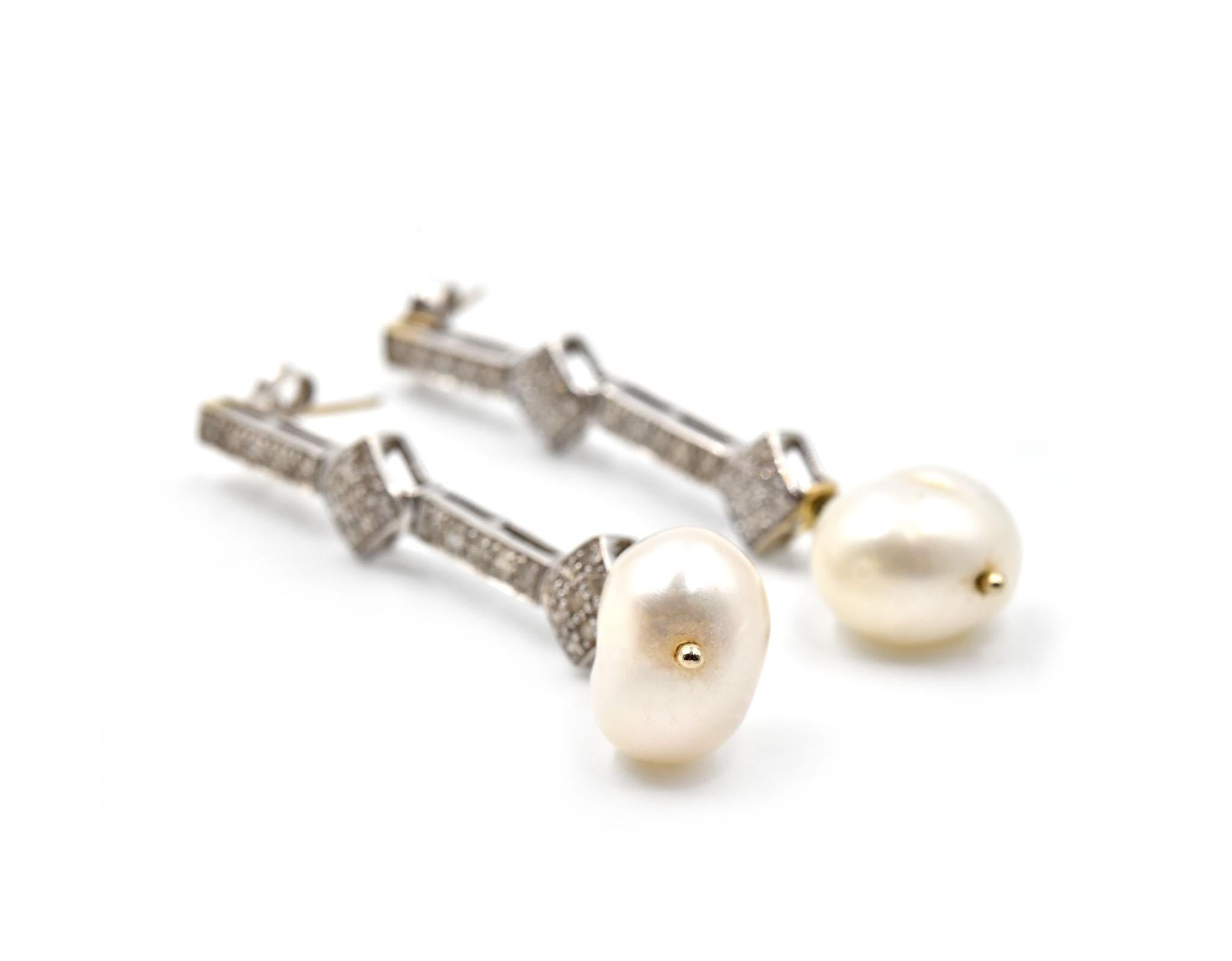 Designer: custom design
Material: 18k white gold
Diamonds: 56 round brilliant cut = 0.76 carat weight
Color: I
Clarity: SI1
Pearls: 11.5-12mm cultured pearls
Fastenings: friction backs
Dimensions: each drop earring is 2-inch long 
Weight: 7.76 grams
