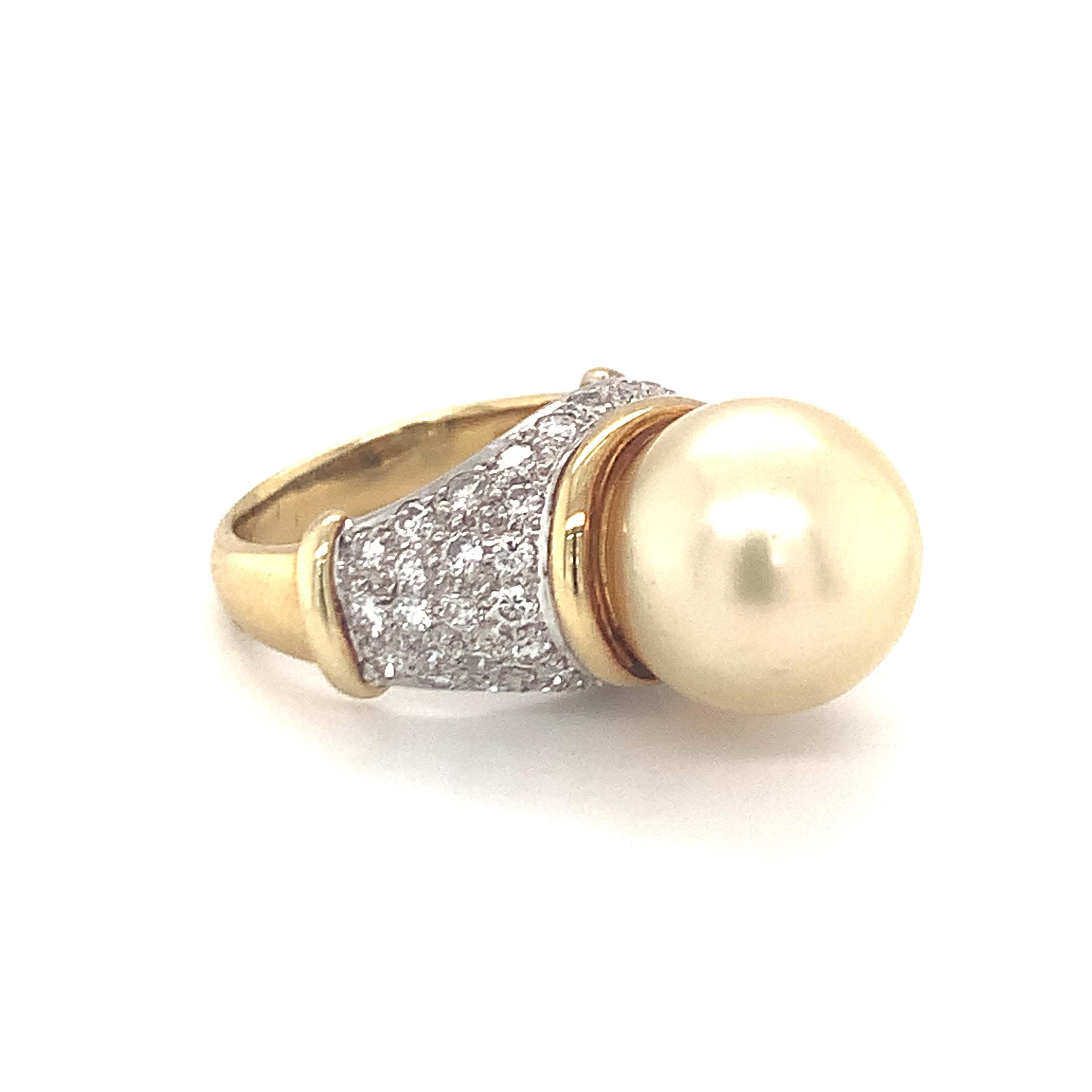 Pearl and diamond 18K yellow gold ring featuring one round golden South Sea pearl measuring 13 millimeters in diameter. Further enhanced by fifty round brilliant cut diamonds totaling 1.50 ct. with G color and VS-1 clarity. Part of matching set with
