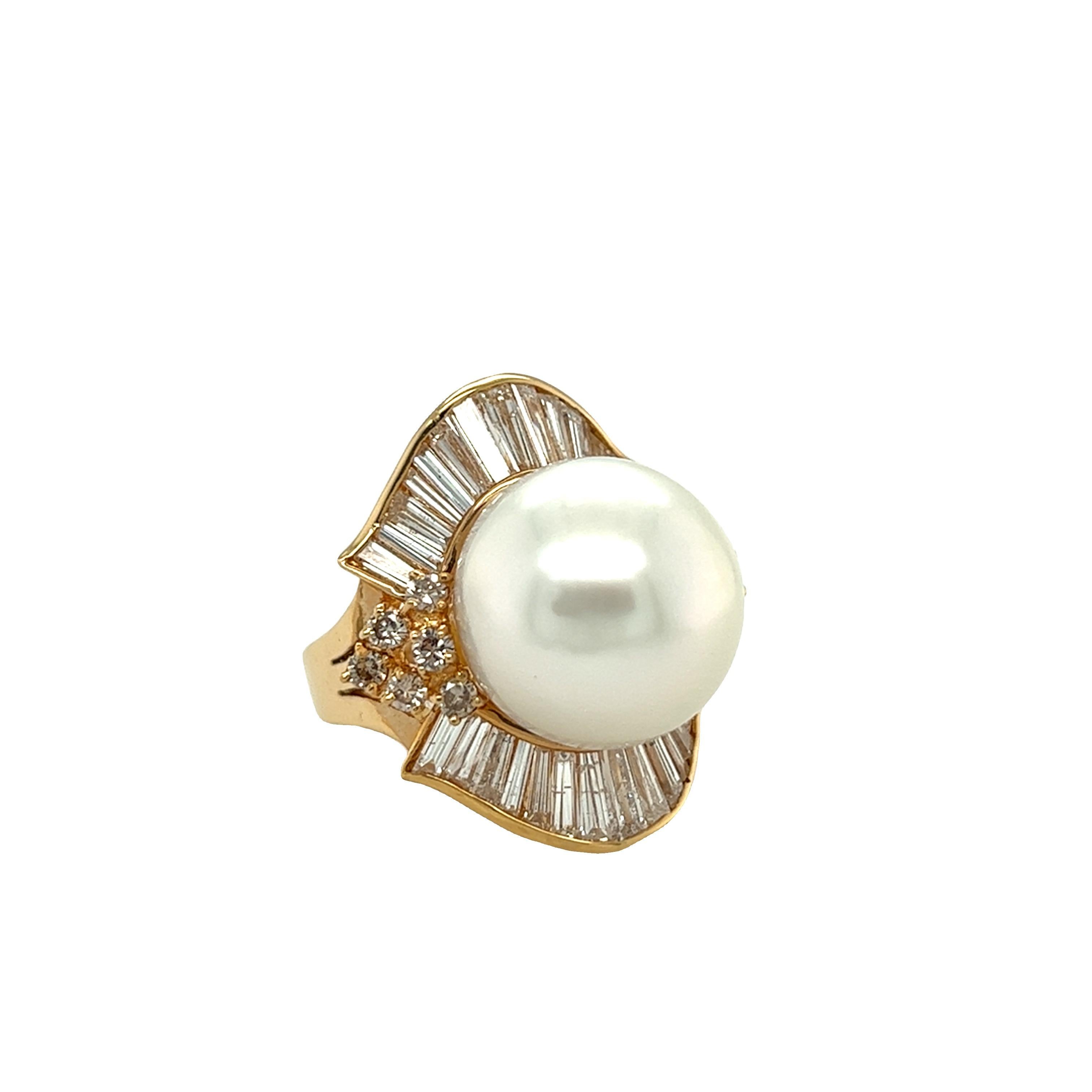 Gorgeous pearl and diamond ring features white round pearl about 14.6 mm. with high luster. The pearl is beautifully wrapped around with round and baguette diamond in ballerina skirt design. It is crafted in 14k gold and is the perfect ring to