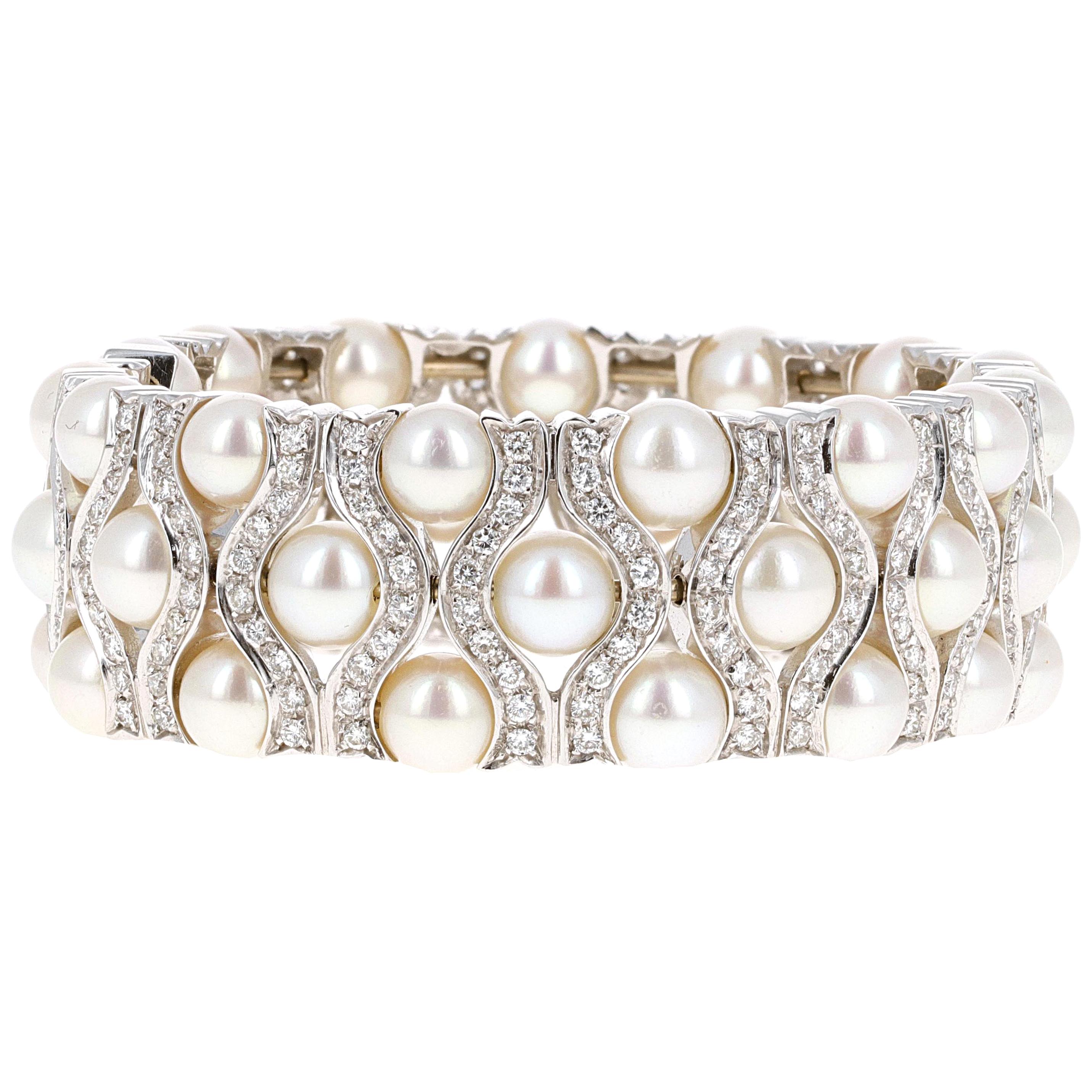 18 karat white gold natural pearl and diamond cuff bangle bracelet. The cuff has slight flexibility allowing you to place it on your wrist with ease and remove it worry free. The cuff has 300 white round brilliant diamonds,  in the bracelet weighing