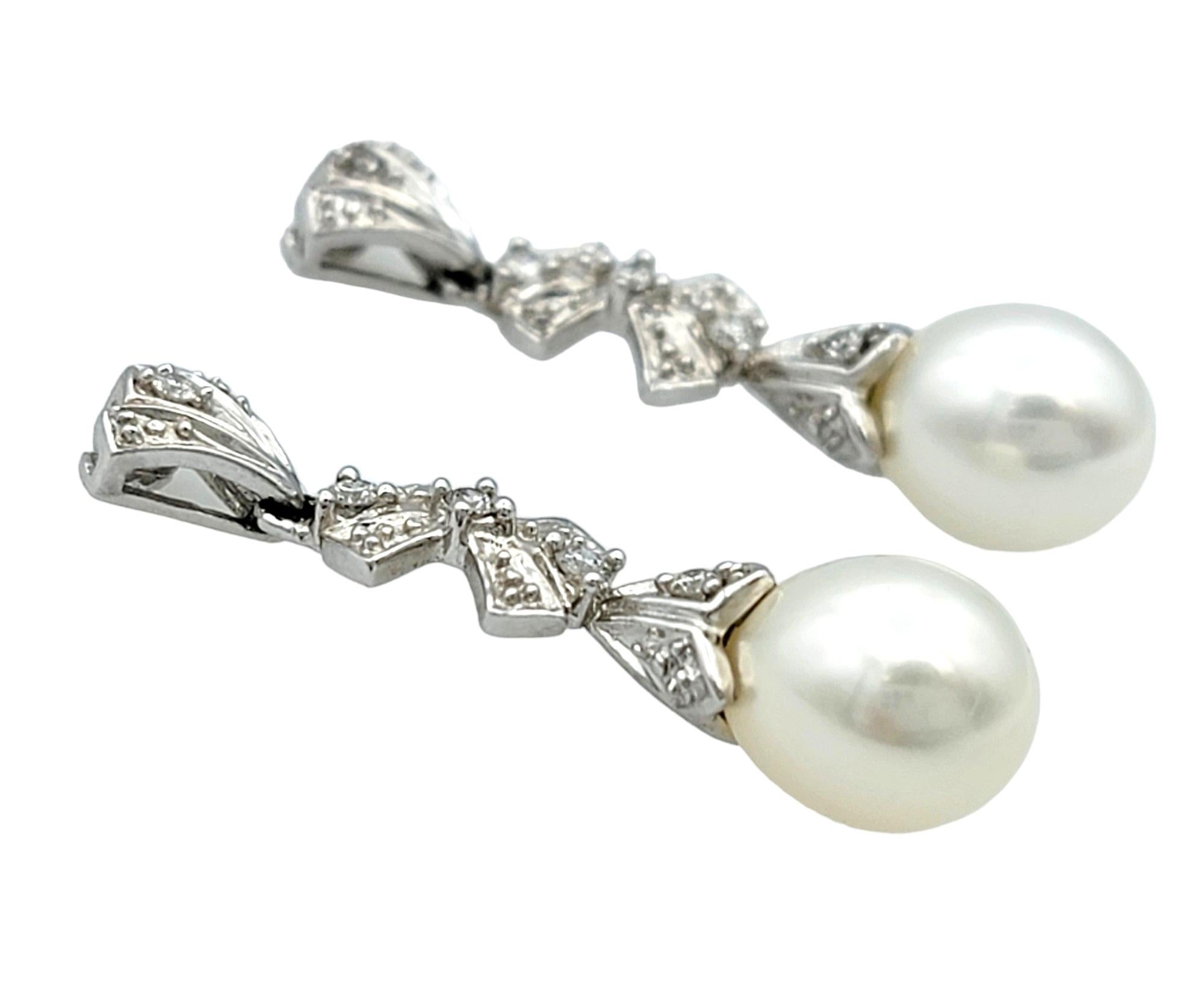 Contemporary Pearl and Diamond Bow Design Dangle Earrings Set in 14 Karat White Gold For Sale