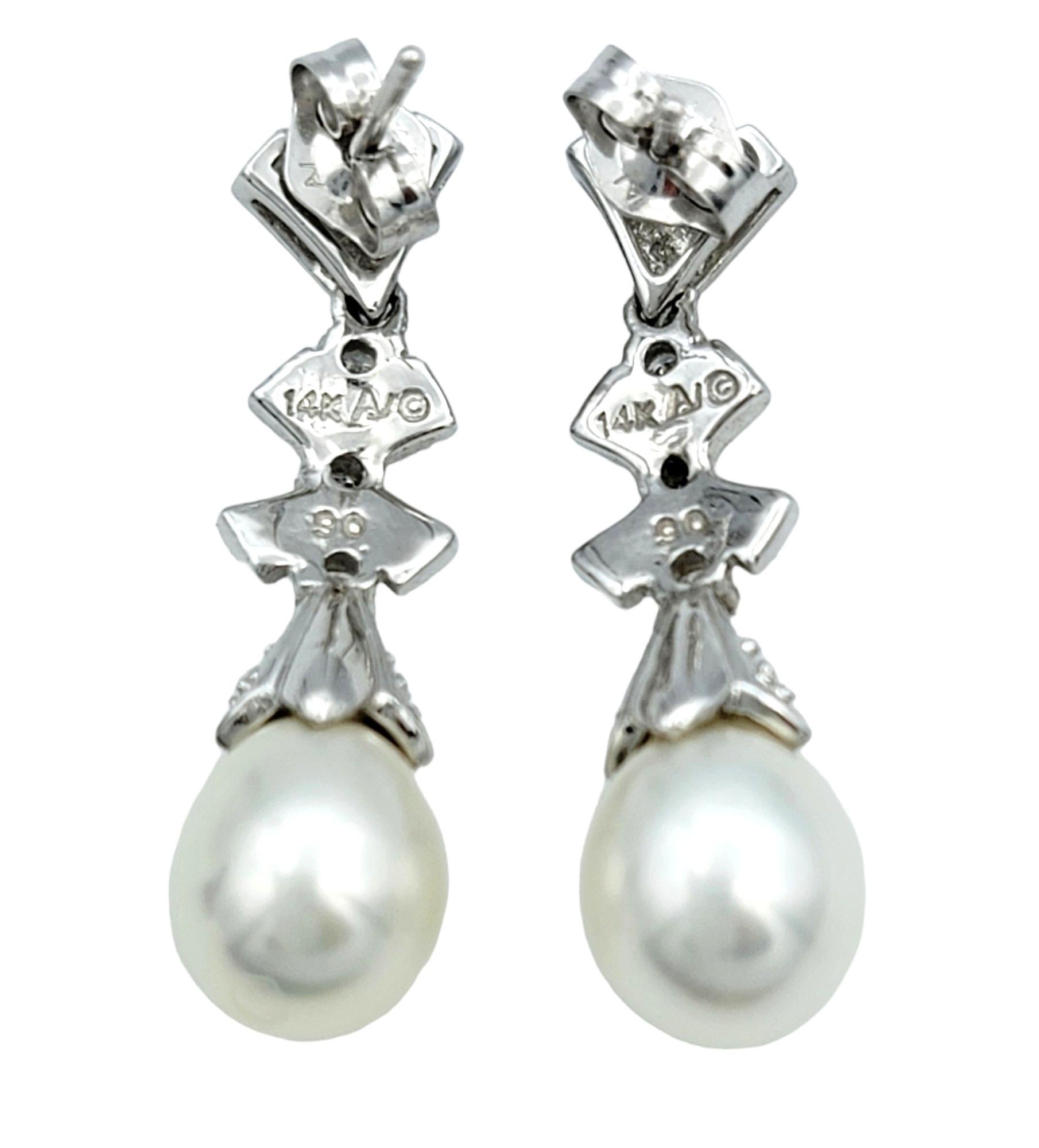 Round Cut Pearl and Diamond Bow Design Dangle Earrings Set in 14 Karat White Gold For Sale