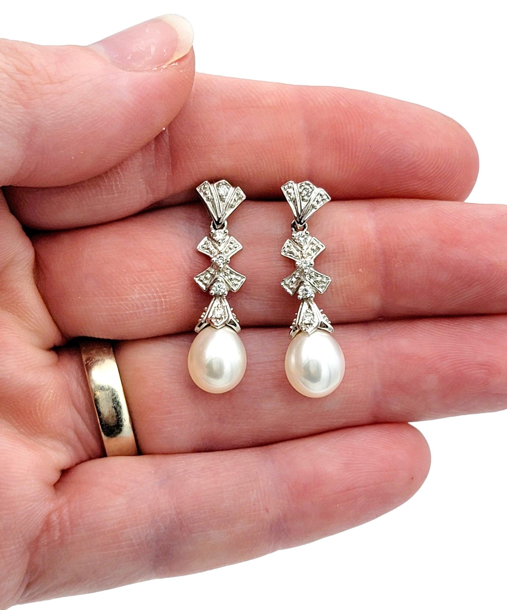 Pearl and Diamond Bow Design Dangle Earrings Set in 14 Karat White Gold For Sale 1