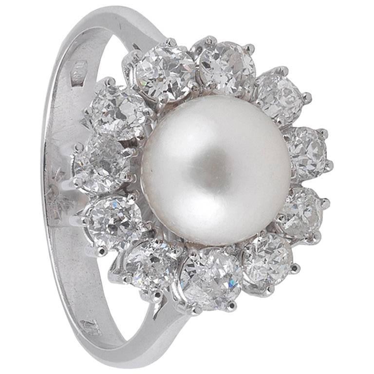 BERNARDO ANTICHITÀ PONTE VECCHIO FLORENCE
The 7.0mm pearl within a surround of old brilliant-cut diamonds, mounted in 18 carat white gold, diamonds approx. 0.75ct total, pearl untested, ring size 7