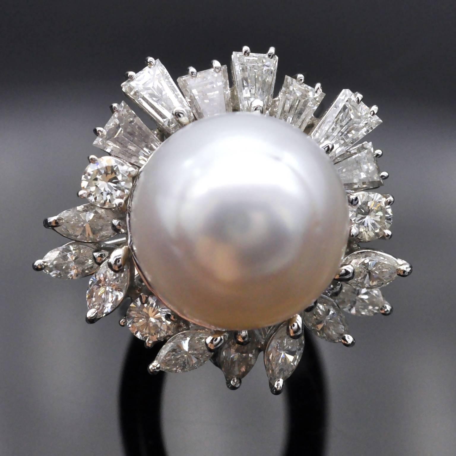Important pearl ring. This alluring cocktail ring measuring 22 mm is composed by a 13.7mm lustrous white south-sea pearl surrounded by a spray of marquise, round and tapered diamonds . 
The diamonds weigh approximately 1.70 carats, graded G-H color