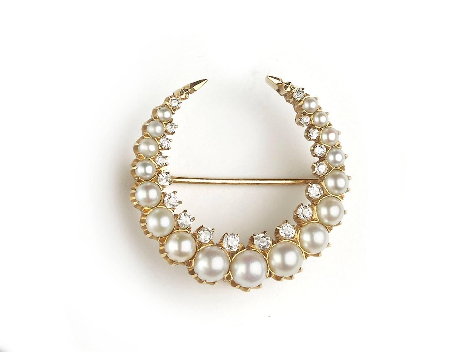 A pearl and diamond crescent, set with seventeen graduated pearls and old cut diamonds, mounted in 14ct gold, with interchangable brooch and pendant fittings, makers mark C & Co and numbered 5846
