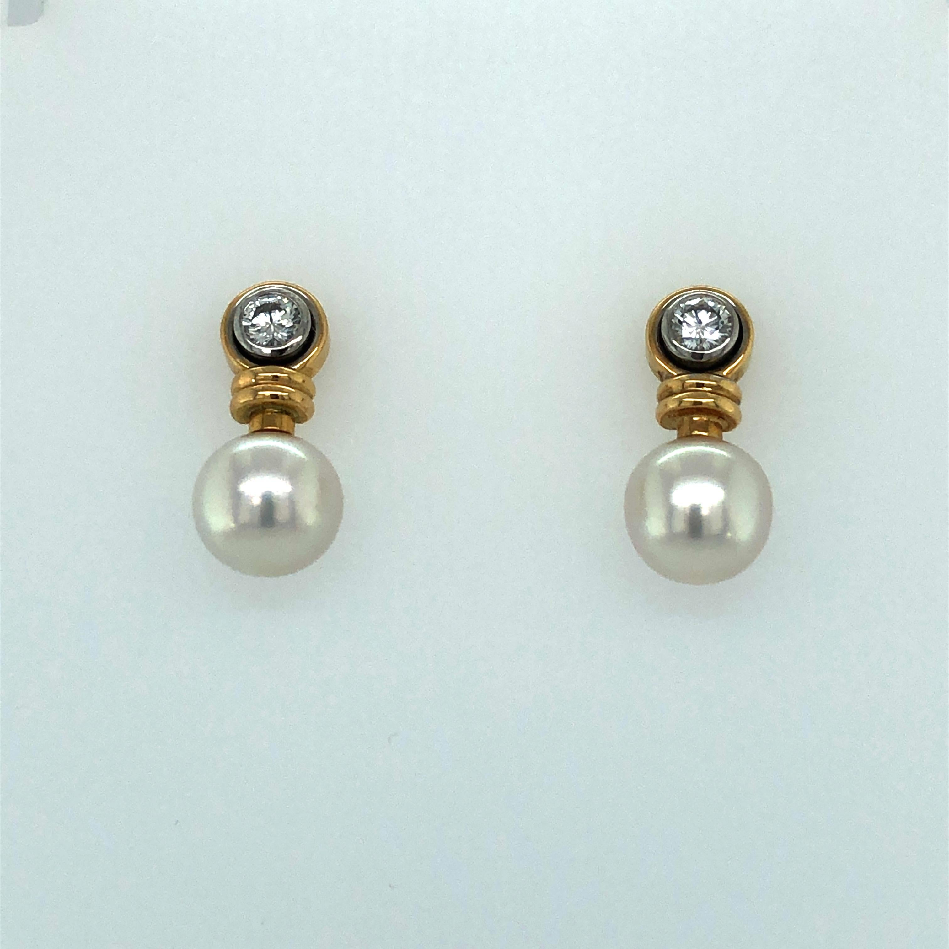 Cute pair of ear studs made in 18K yellow- and white gold. Two white and clean Akoya Cultured Pearls of 8.3 mm in size. Set on top in a white gold bezel with two full brilliant-cut diamonds totalling 0.32 ct. Fine G/H-vs quality. Fine goldsmith work