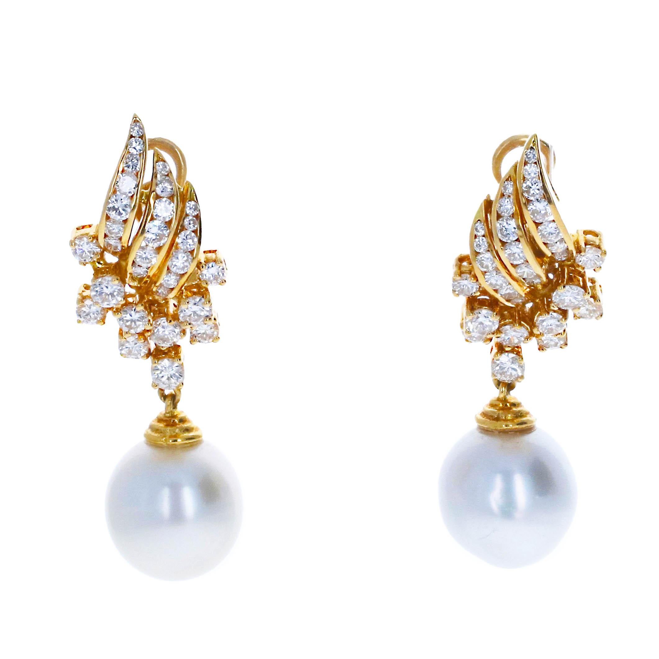 This stunning 18k yellow gold earrings and ring set is a timeless celebration of elegance, featuring luminous 12-15mm pearls and bright, sparkling diamonds. The earrings are 1.5 inches long, showcasing a large, lustrous pearl gracefully dangling