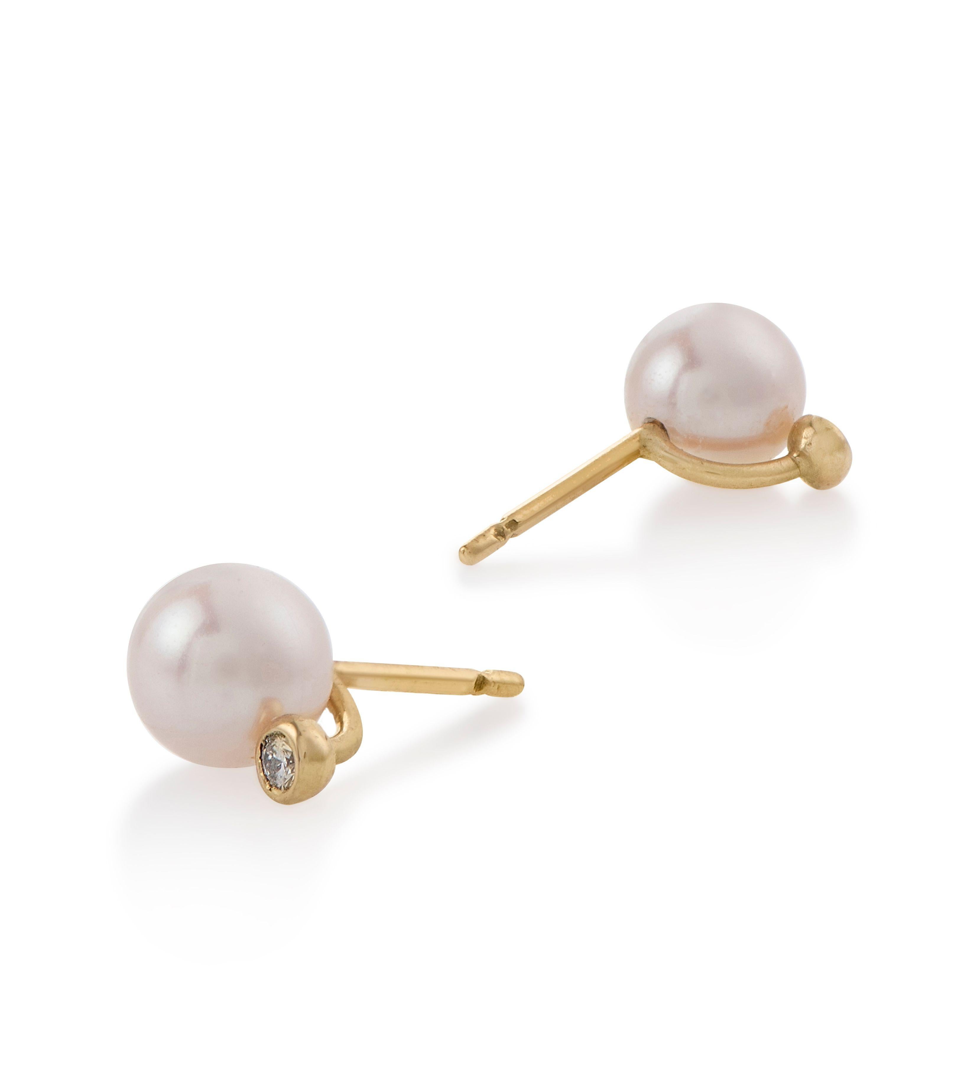 These chic and timeless mini studs, are the perfect everyday pair of earrings. They are set with lustrous pearls and beautifully complimented by a pair of glimmering diamonds. Wear them with the diamond facing diagonally on the ear for a more