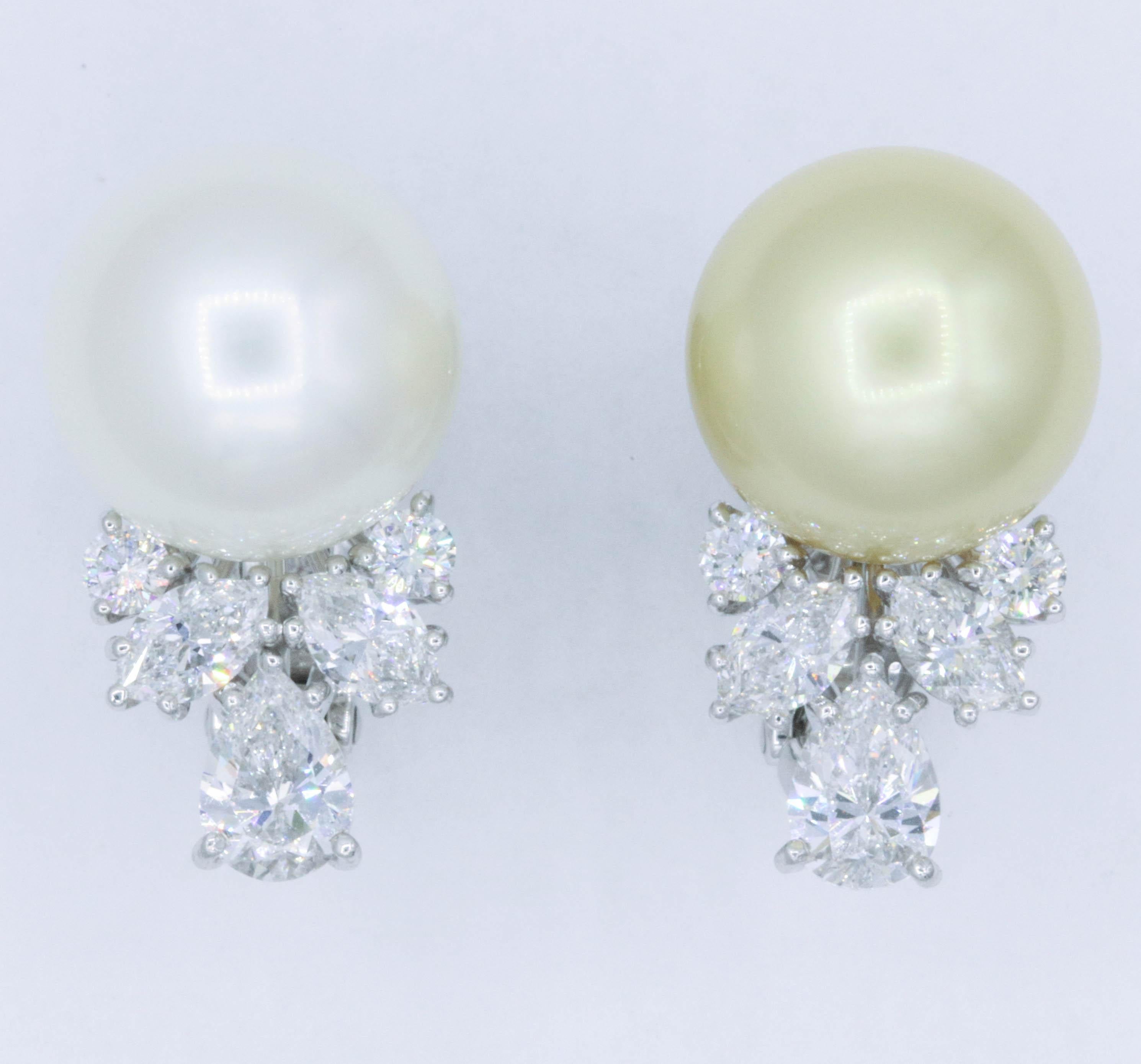Elegant pair of mismatch pearl earrings featuring four marquise weighing 1.02 carats and four round diamonds weighing 0.37 carats, in platinum.
Pearls: 13.2-13.3 MM
Color: G
Clarity: VS