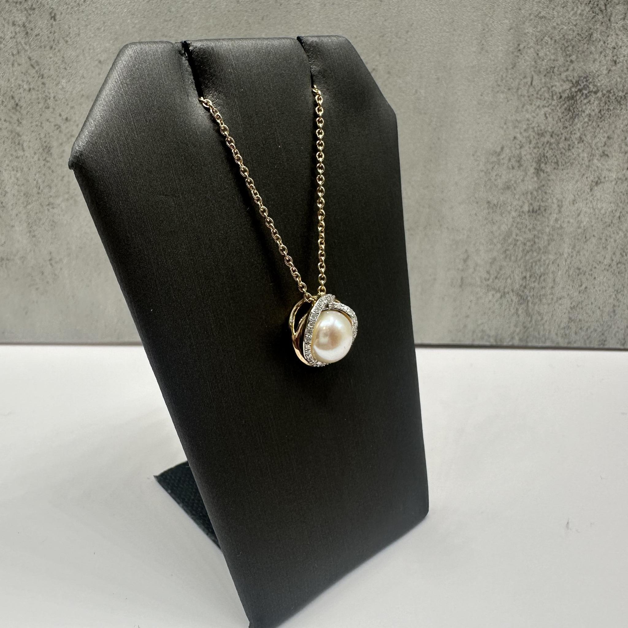 This elegant Pearl and Diamond Necklace in 10kt yellow gold features an 8mm pearl, complemented by 0.15ctw of natural GH I1 round single-cut diamonds, adding a delicate sparkle. The length is adjustable up to 18 inches, offering versatility for