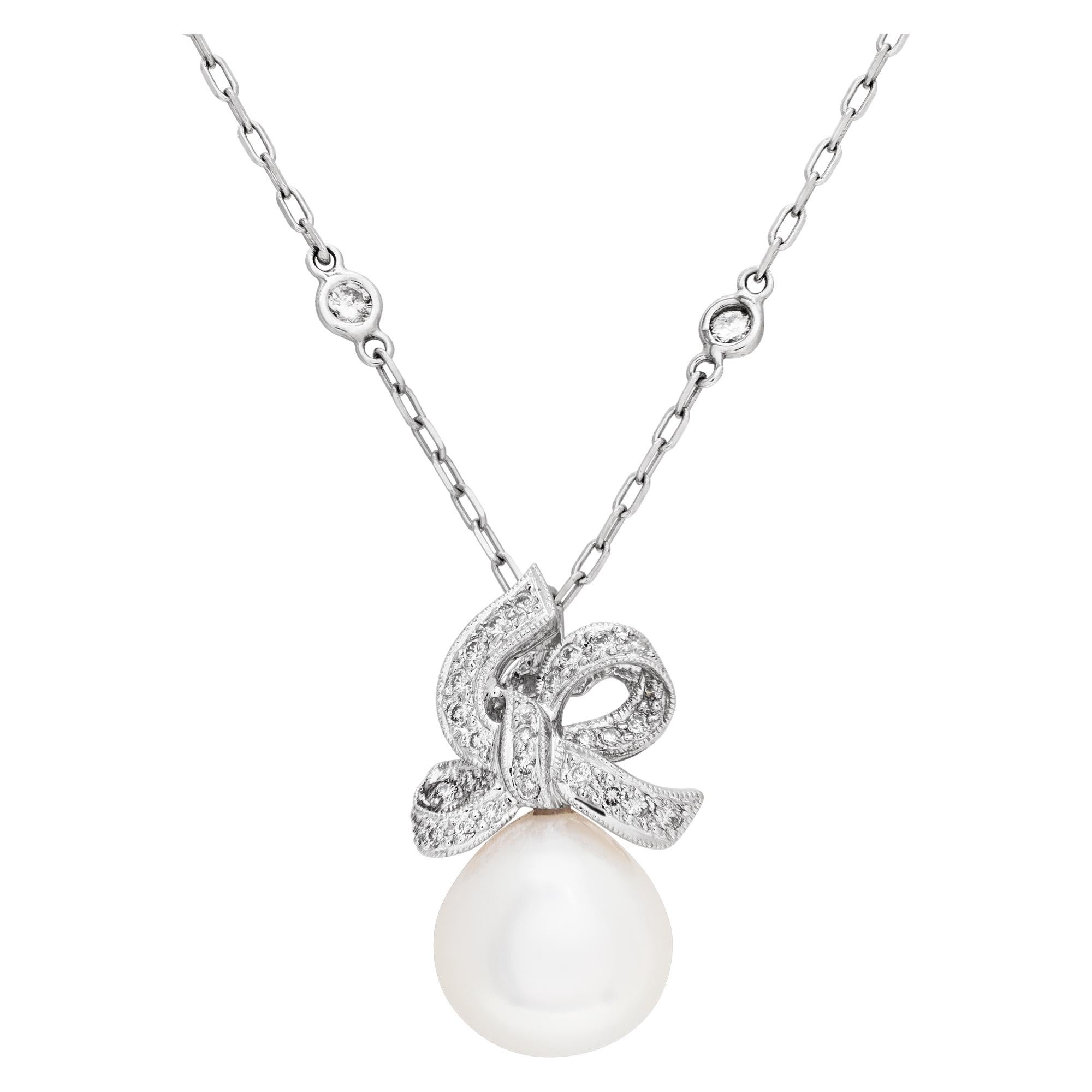 Pearl and diamond pendant in 18k white gold with 14k white gold diamonds by the yard chain. 12mm tear drop shaped pearl with silver overtone. Approximately 1.08 carats in round diamonds. 18 inch length.