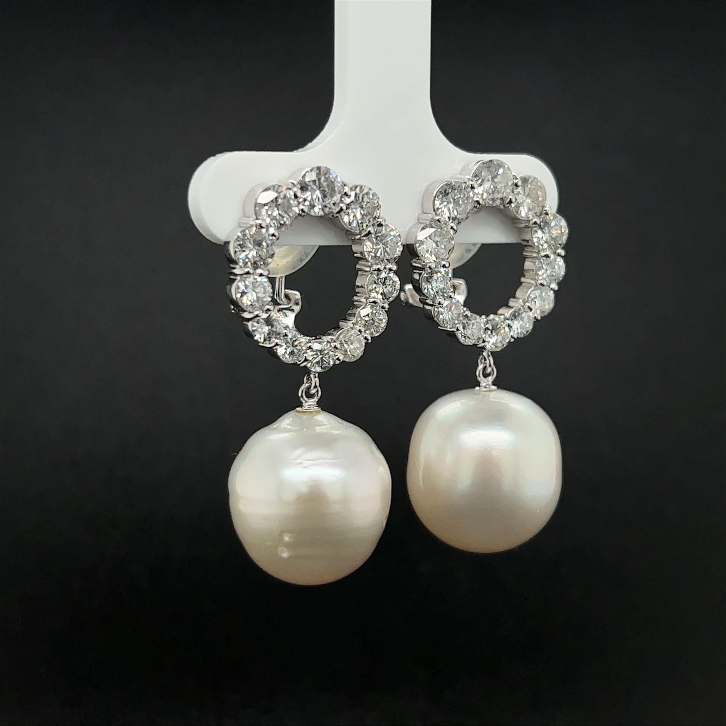 Simply Beautiful! 14.5mm White Pearl Drop Platinum Earrings. Each earring suspended from circular a top, Hand set with SI-I2 White Diamonds, approx. 3.18tcw. Hand crafted Platinum mountings. Tops marked: PT900 1.60