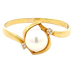 Bague en or jaune 18k avec perles et diamants