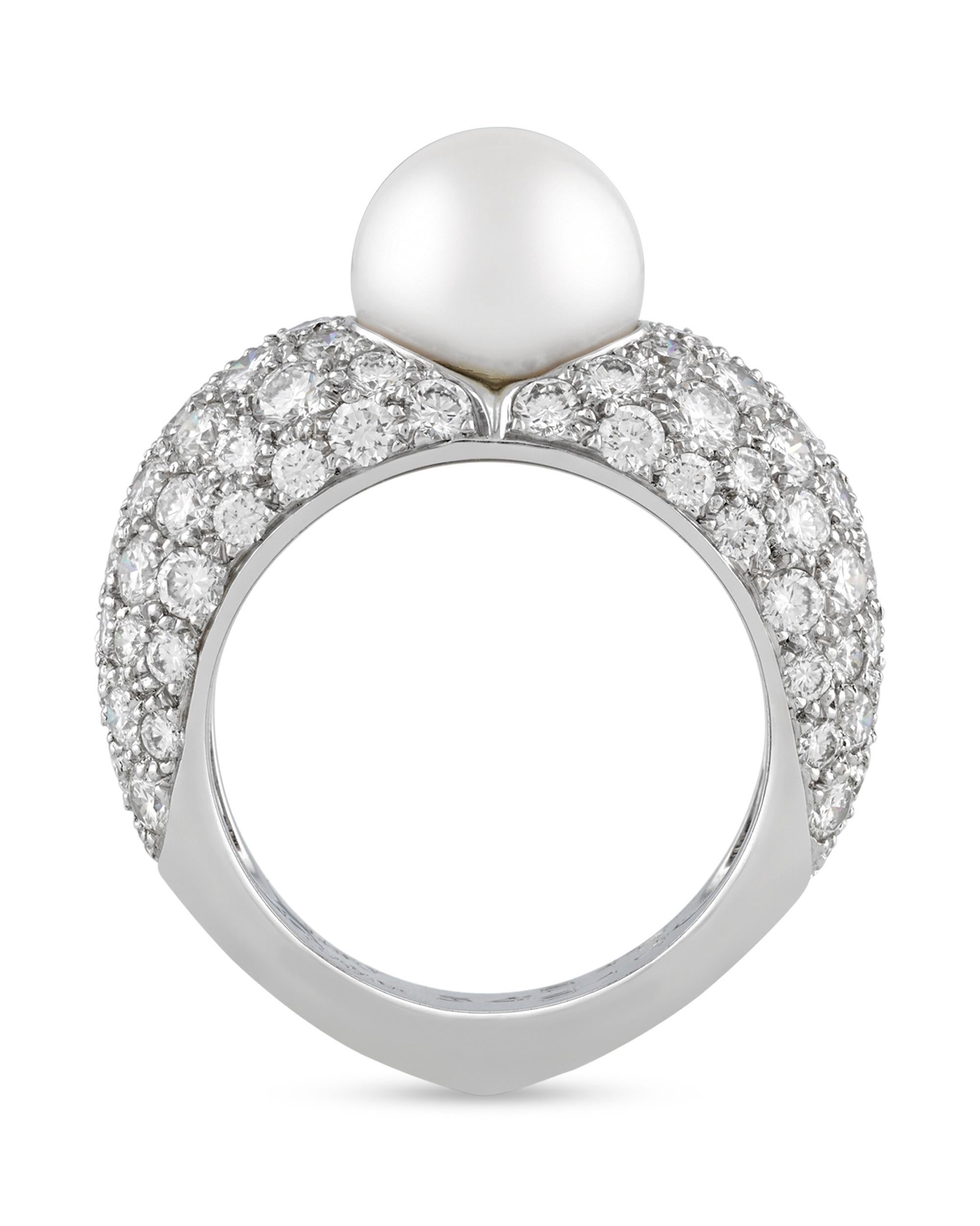 This classic and stylish ring from the celebrated house of Cartier is an elegant example of modern jewelry design. Crafted of 18K white gold, the ring is set with a 9mm white pearl at its center, while approximately 1.00 total carat of diamonds are