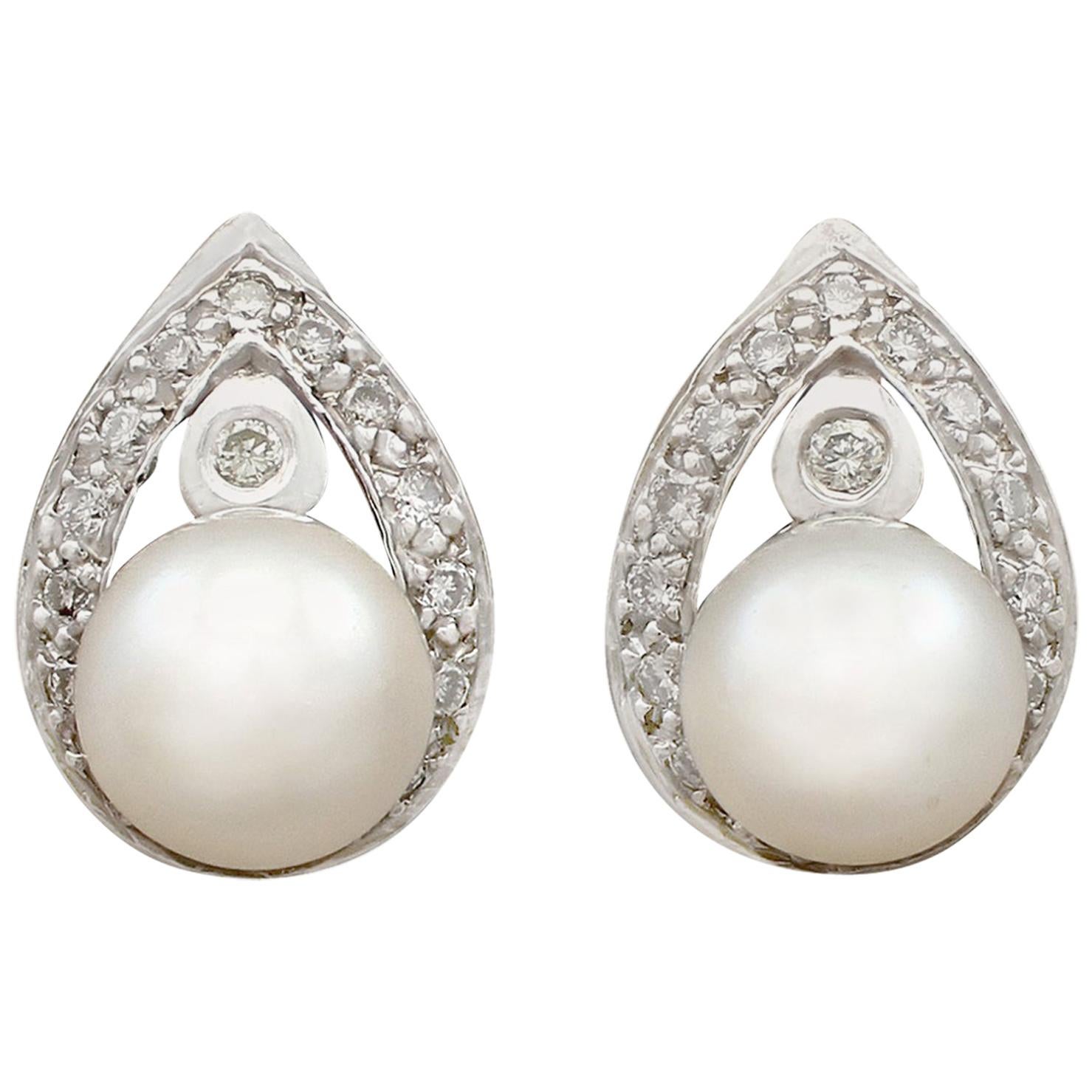 An impressive pair of vintage cultured pearl and 0.28 carat diamond, 14 karat white gold stud earrings; part of our diverse vintage jewellery and estate jewelry collections.

These fine and impressive vintage pearl earrings have been crafted in 14k