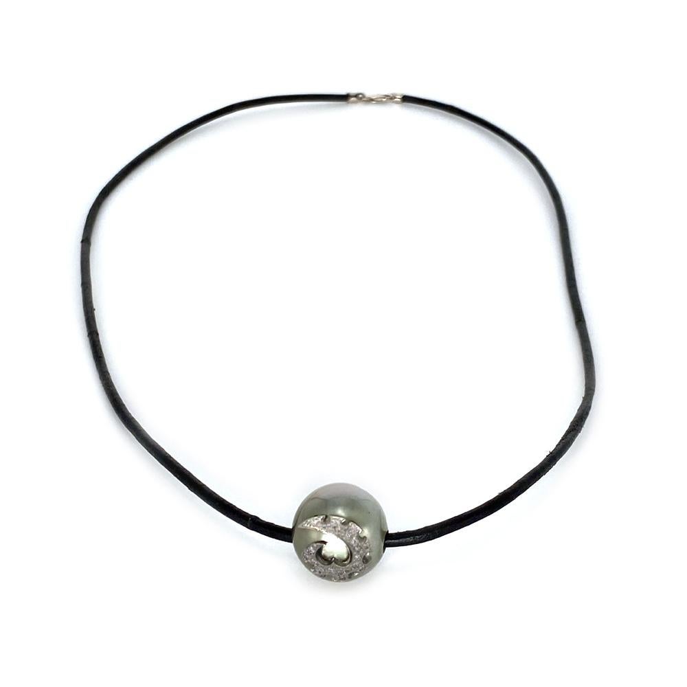 This pendant in 18k white gold features a Tahitian pearl and Time Traveler symbol set with .46 carat total weight diamonds on a leather cord.

The Body Armor Collection embodies eternal symbols of protection that are both tribal and elegant. These