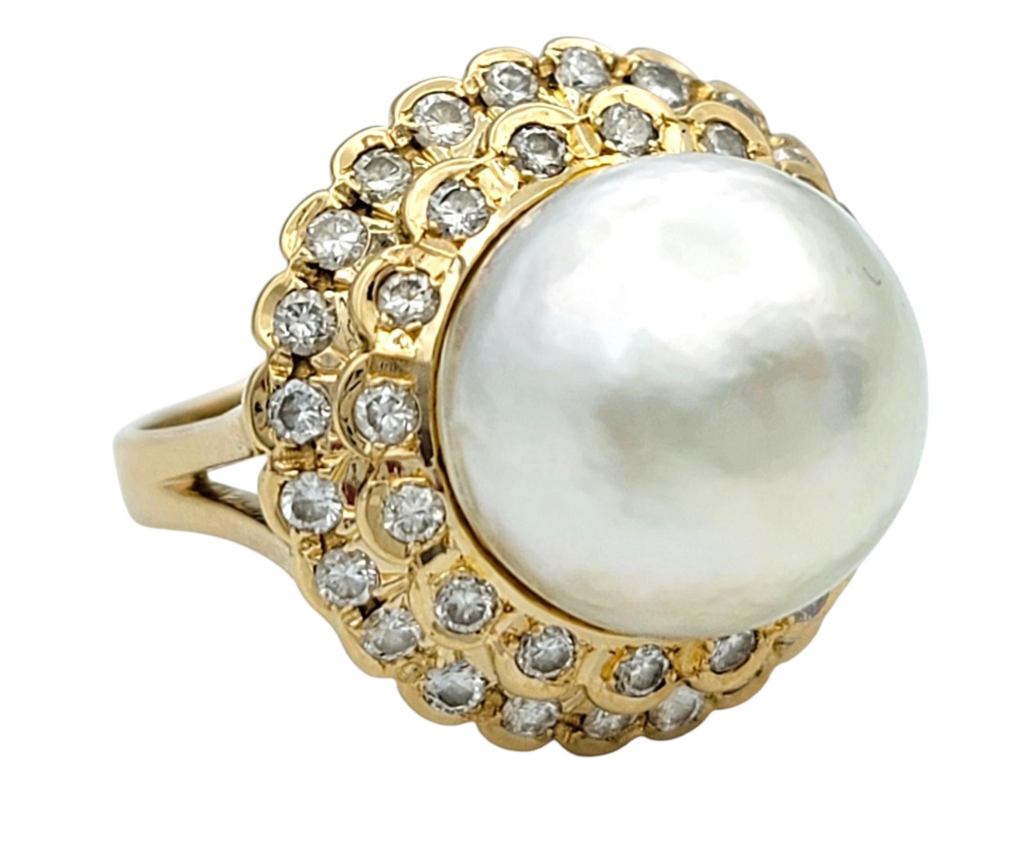 Ring Size: 6.5

This exquisite ring showcases a luminous cultured pearl, exuding timeless elegance and sophistication. The large pearl sits gracefully at the center, embraced by a dazzling arrangement of bezel set round-cut diamonds. Expertly set in